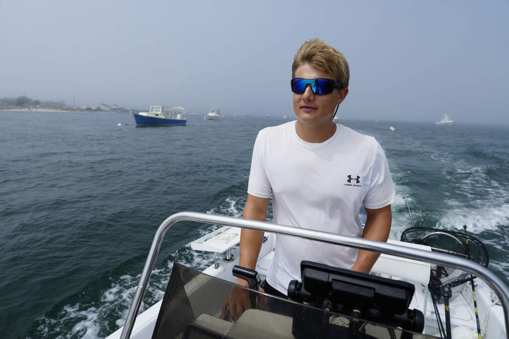 David Lancaster, an avid fisherman who recently captured drone footage off a white shark off of Scarborough, Maine, motors out to sea, Wednesday, Aug. 13, 2025, in Scarborough. (Robert F. Bukaty/AP)