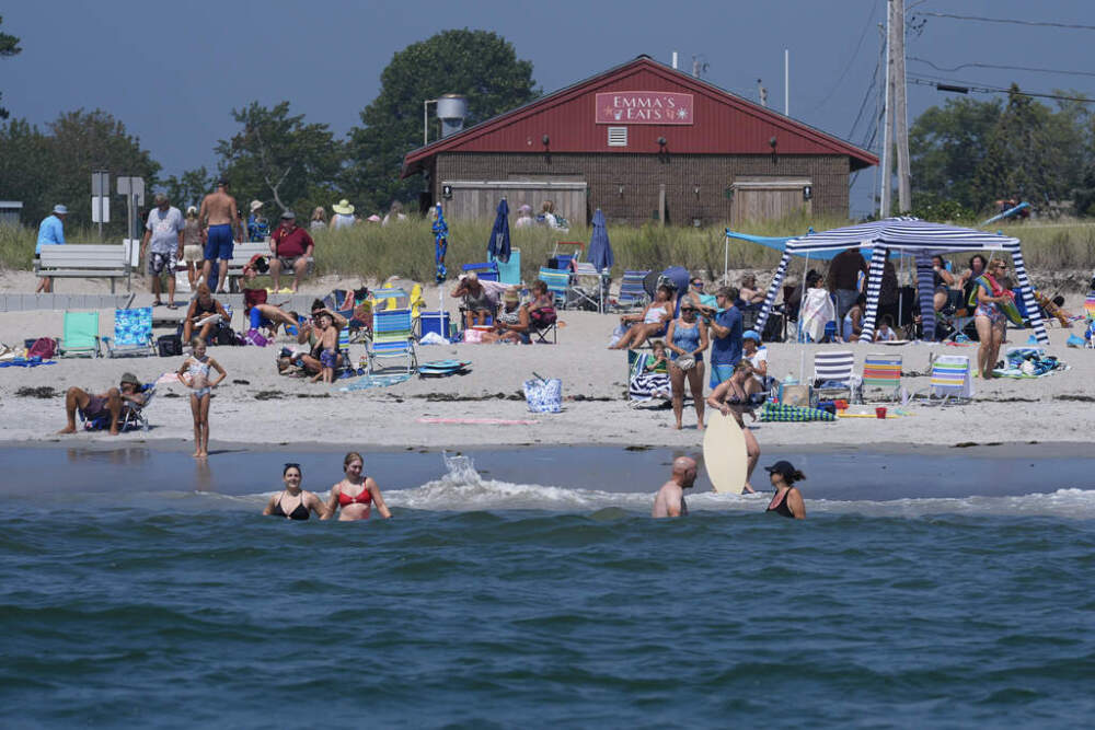 Visitors enjoy the summer weather not far from recent sightings of white sharks, Wednesday, Aug. 13, 2025, in Scarborough, Maine. (Robert F. Bukaty/AP)