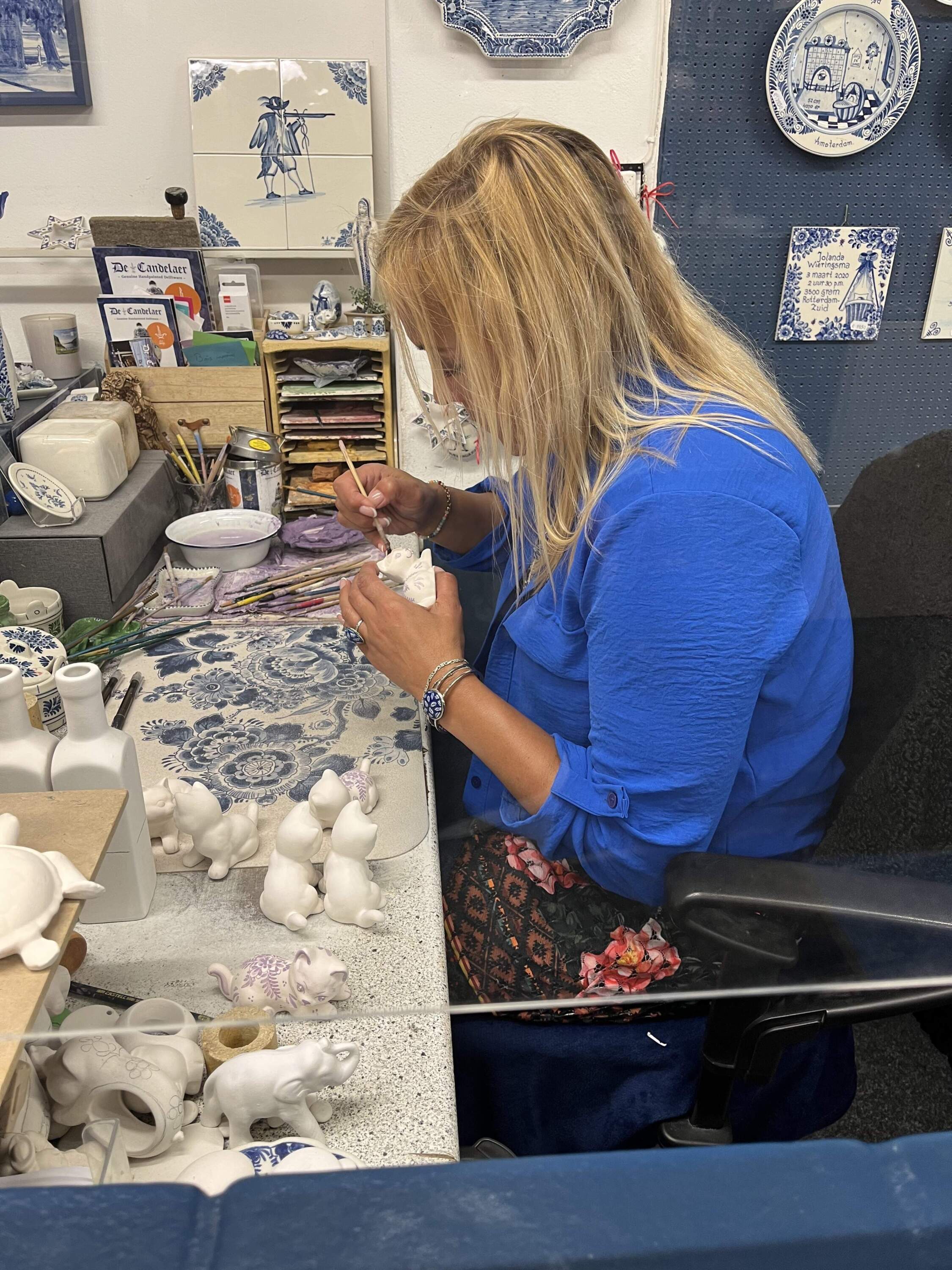 An artist hand paints delftware. (Robin Young/Here &amp; Now)