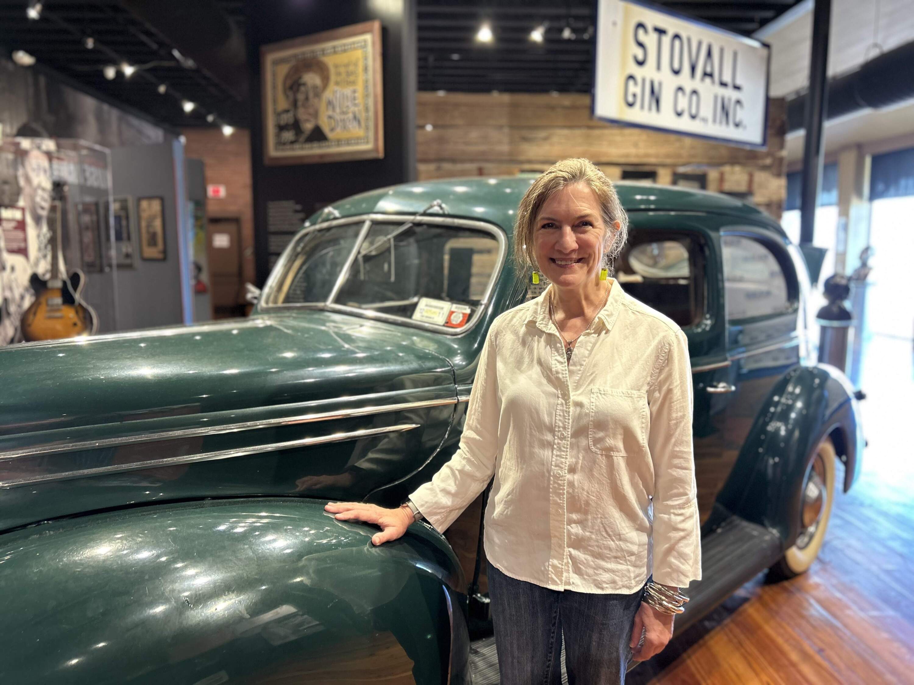 Shelley Ritter, executive director of the Delta Blues Museum in Clarksdale, Miss., in front of a replica vehicle used by Alan Lomax to record blues musicians in the Delta. (Peter O'Dowd/Here &amp; Now)