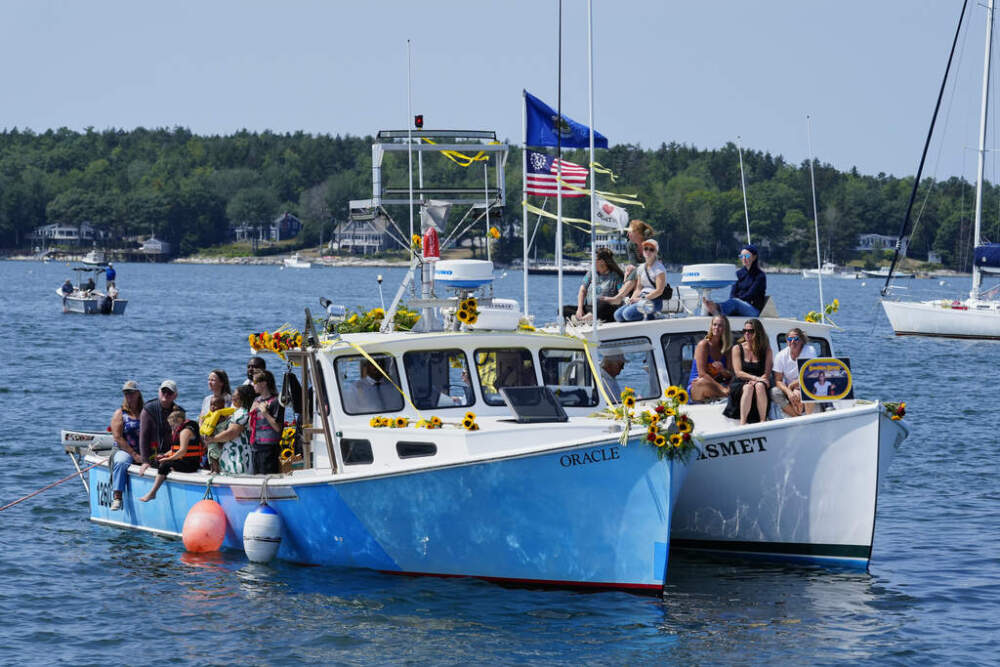 Friends and family attend a memorial service for Sunshine Stewart, Sunday, Aug. 10, 2025, off the coast of St. George, Maine. (Robert F. Bukaty/AP)