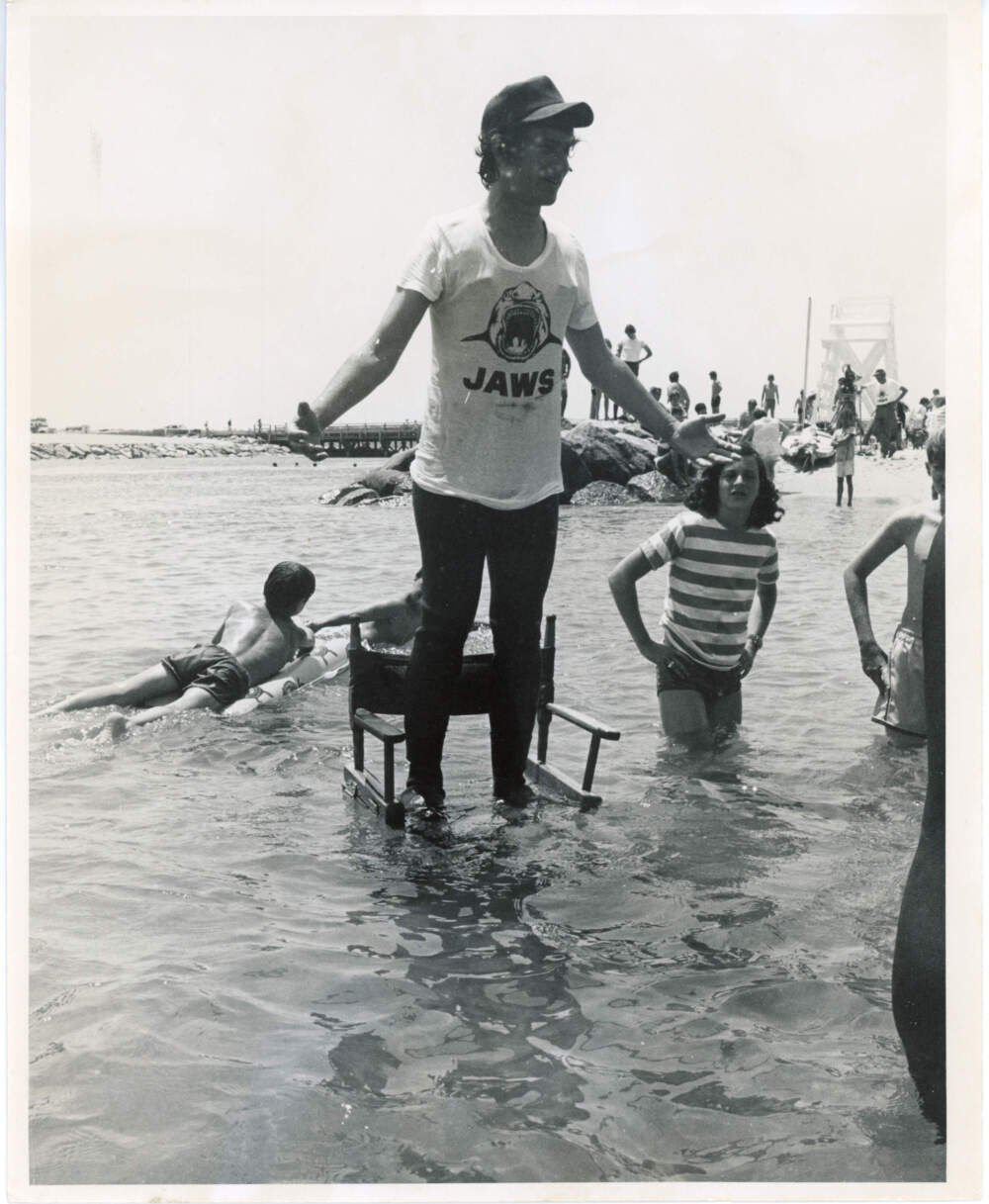 Steven Spielberg stands on a director's chair in the ocean. (Courtesy of Edith Blake/Martha's Vineyard Museum)