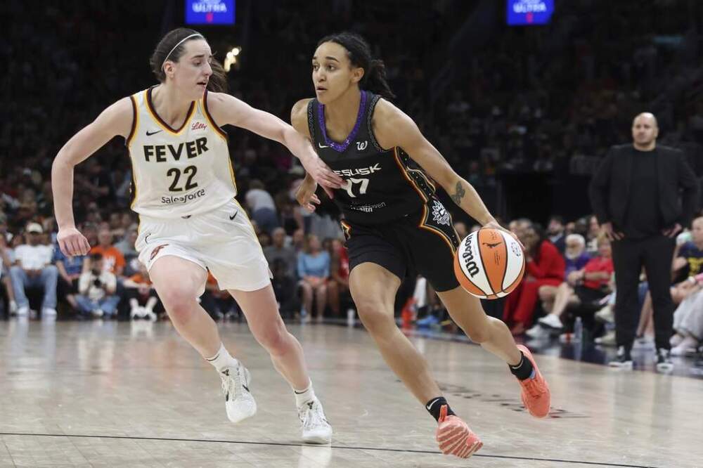 Connecticut Sun's Leila Lacan (47) drives past Indiana Fever's Caitlin Clark (22) during the second half of a WNBA game, Tuesday, July 15, 2025, in Boston. (Michael Dwyer/AP)