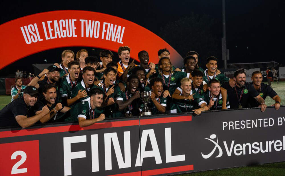 Vermont Green FC players pose for a photo after winning the championship. (Brian Stevenson/Vermont Public)