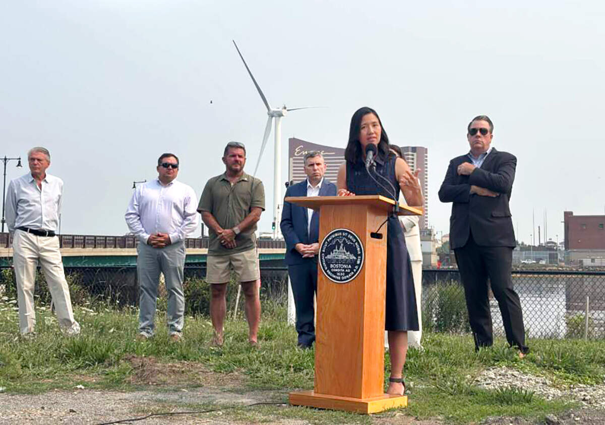 Boston Mayor Michelle Wu flanked by Charlestown residents and local officials as she spoke against the Kraft Group's "nonstarter" plans to build a new stadium on the Everett-Charlestown line. (Eve Zuckoff/WBUR)