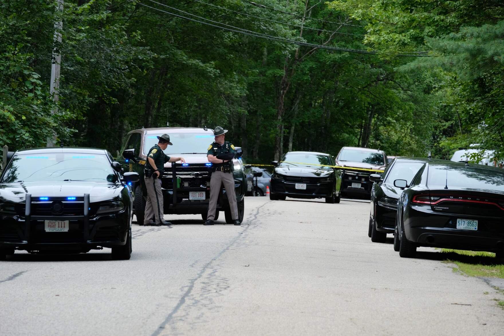 Law enforcement officers outside of the Long's home in Madbury on Tuesday, Aug. 19, 2025. (Todd Bookman/NHPR)