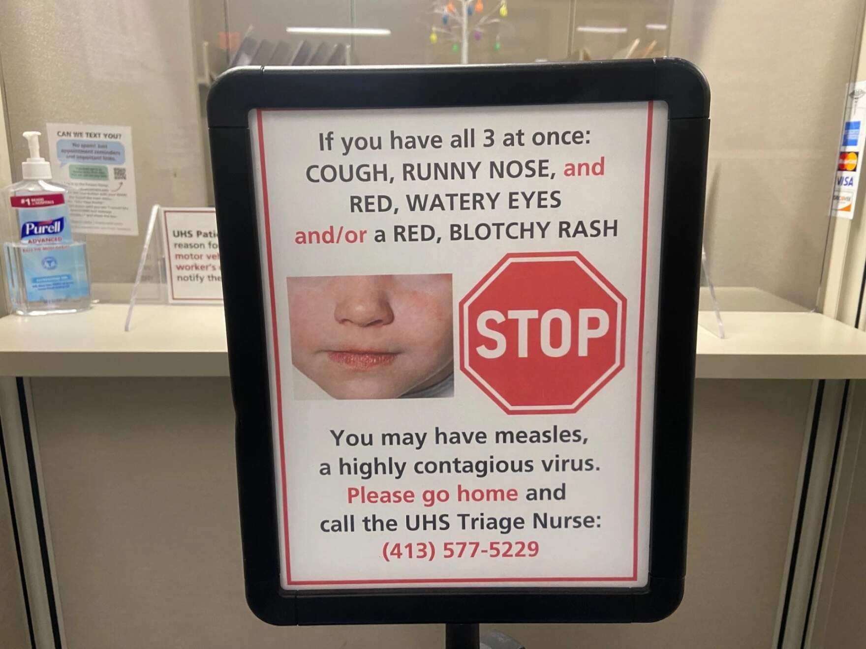 A sign about measles at the UMass health clinic. (Karen Brown/NEPM)