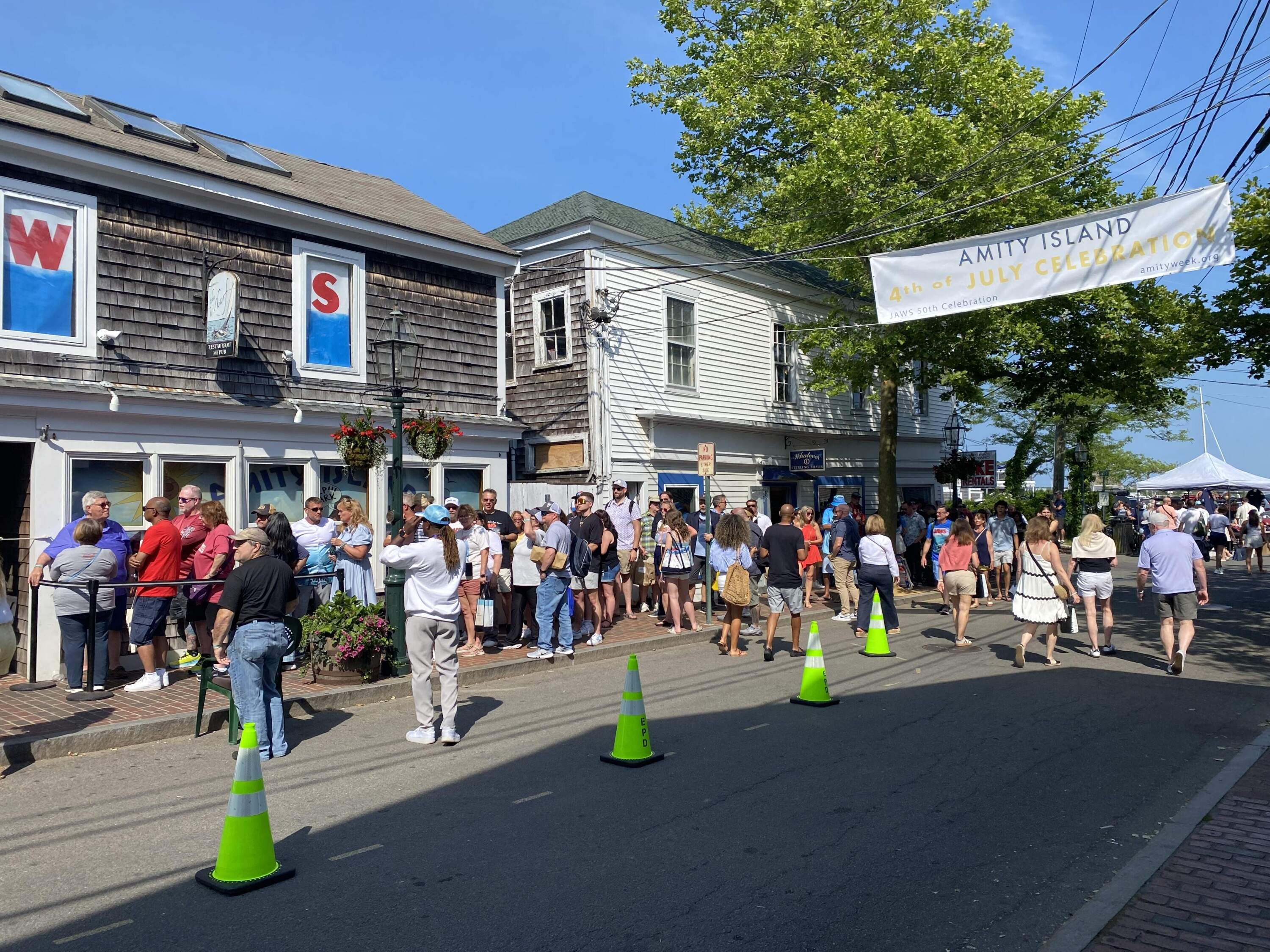 Fans line up outside The Wharf pub during the 50th anniversary weekend in June to collect autographs from "Jaws" cast members. (Andrea Shea/WBUR)