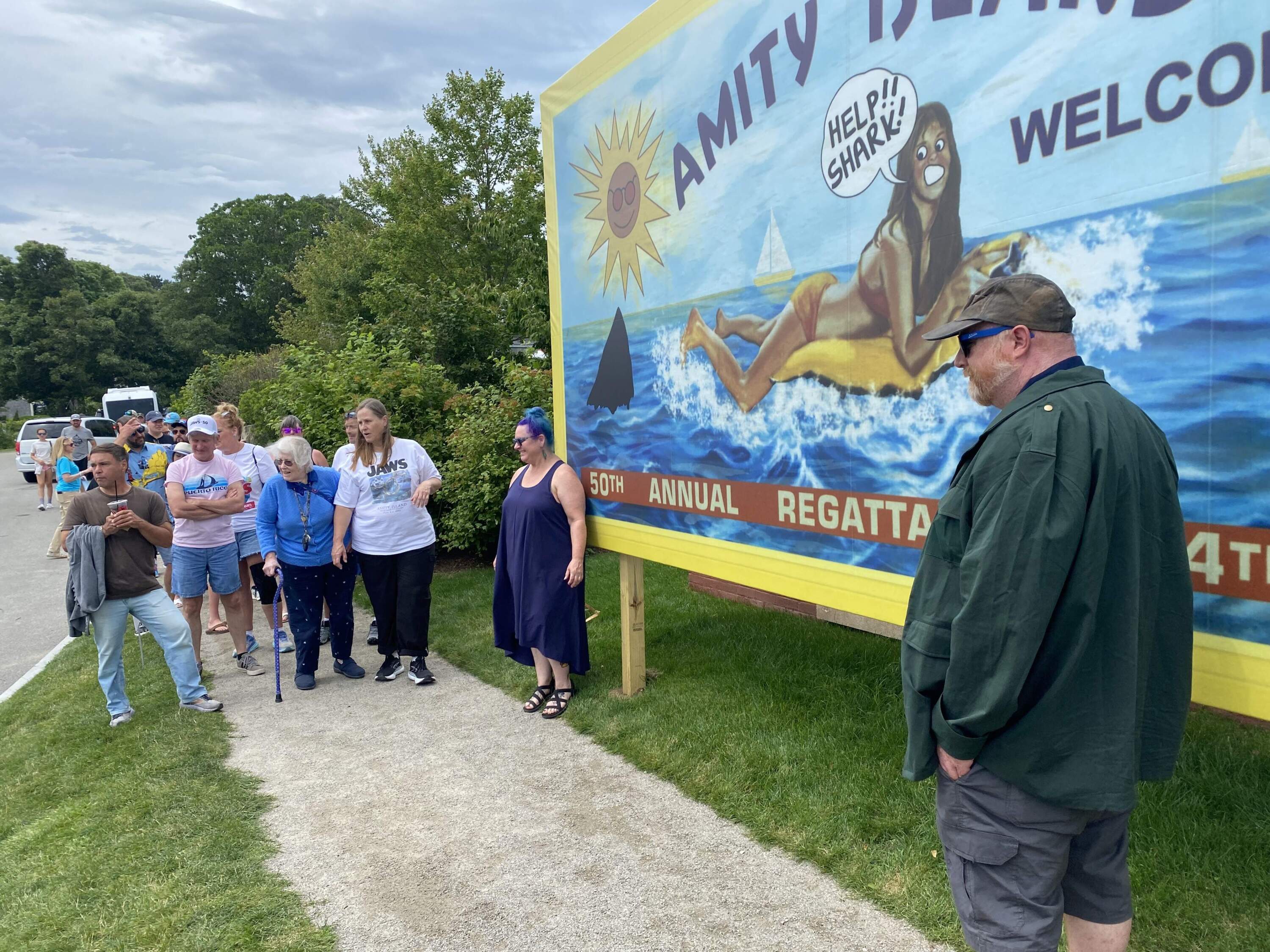 Finatics line up to have their photo taken beside an Amity Island billboard recreated from "Jaws." (Andrea Shea/WBUR)