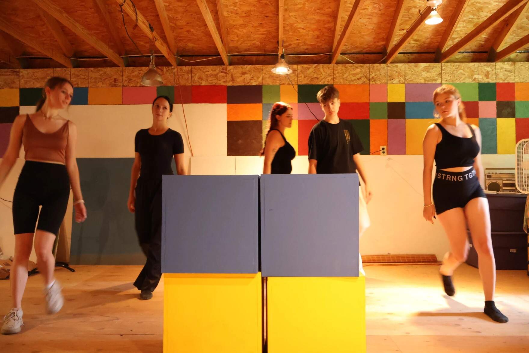 Five Ukrainian actors rehearse the opening number to the musical "Voices from Ukraine," in a barn in Newbury. (Alicia Sanyal/NHPR)