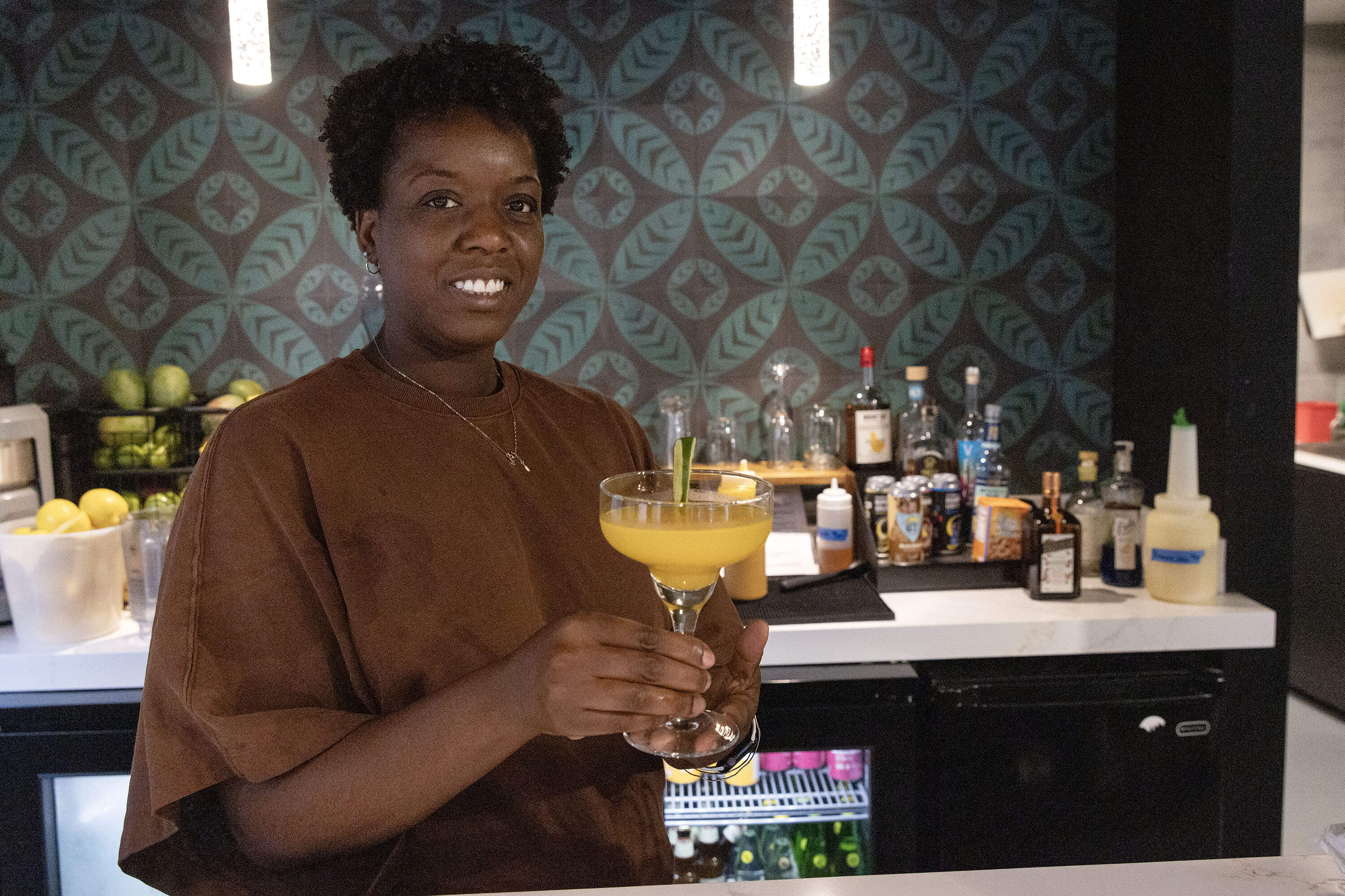 Cassandria Campbell holds a mango margarita at her restaurant, Fresh Food Generation in Dorchester. (Robin Lubbock/WBUR)