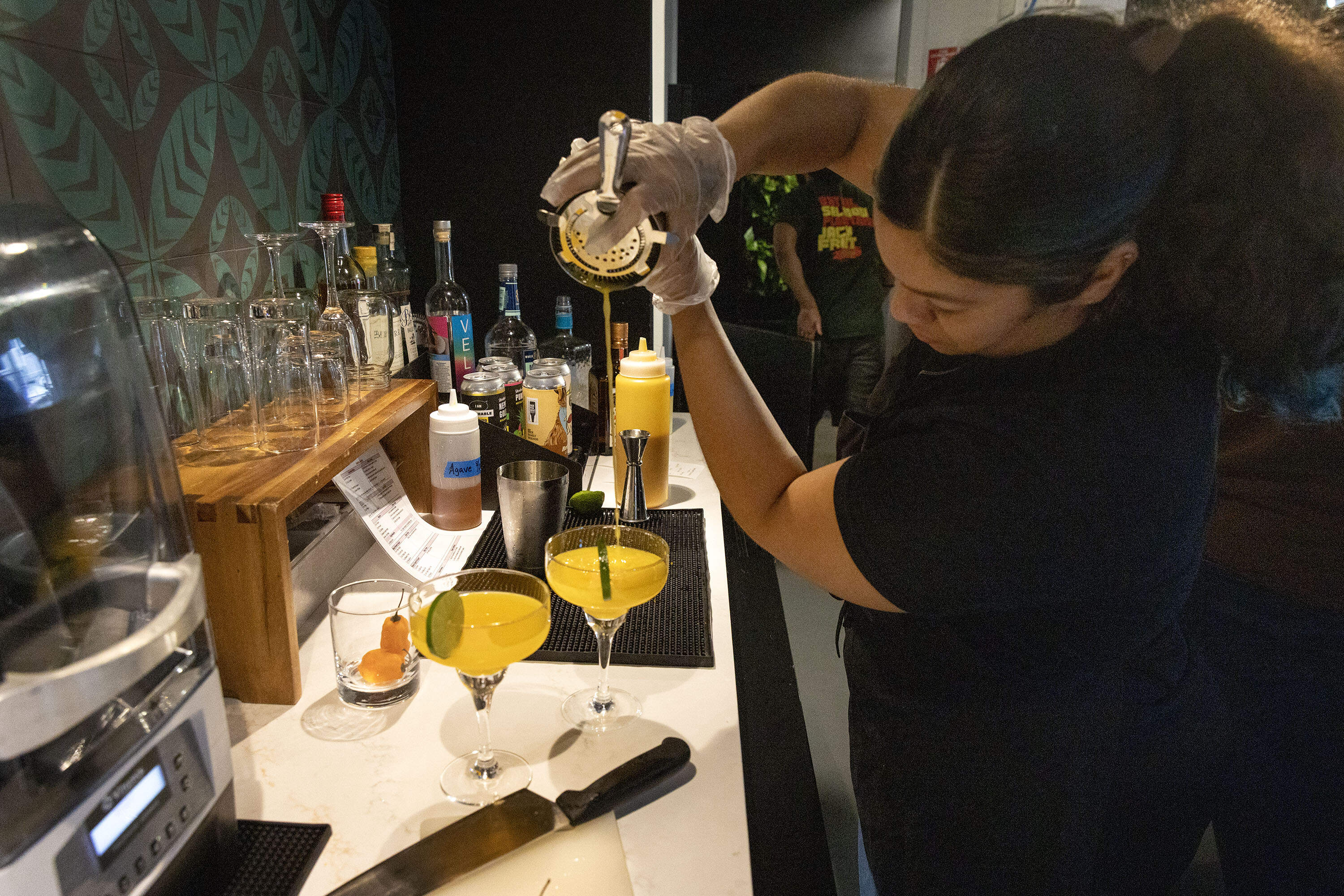 Mixologist Julisa Hernandez prepares a mango habanero margarita at Fresh Food Generation in Dorchester.