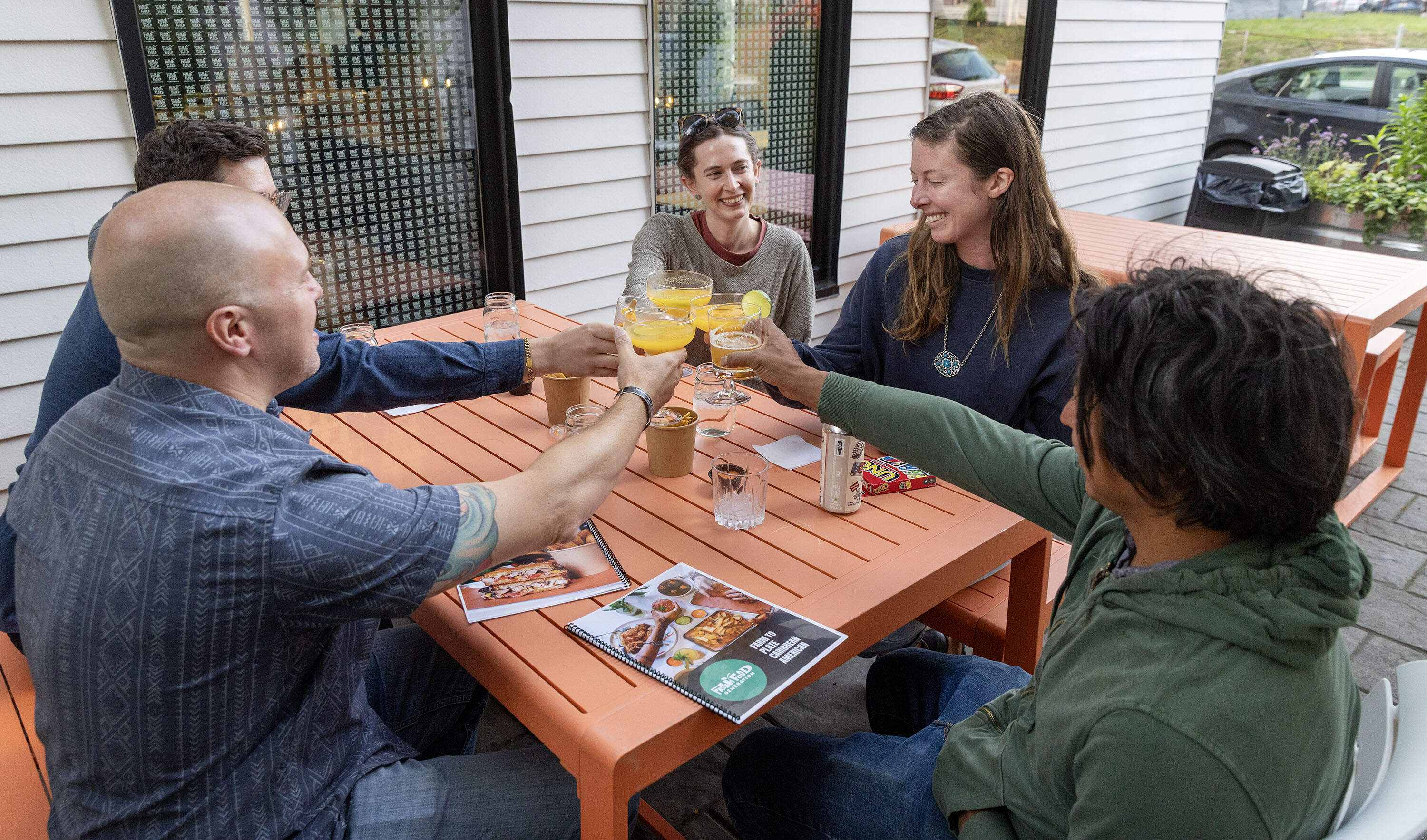 A group of friends toast outside at Fresh Food Generation in Dorchester. (Robin Lubbock/WBUR)