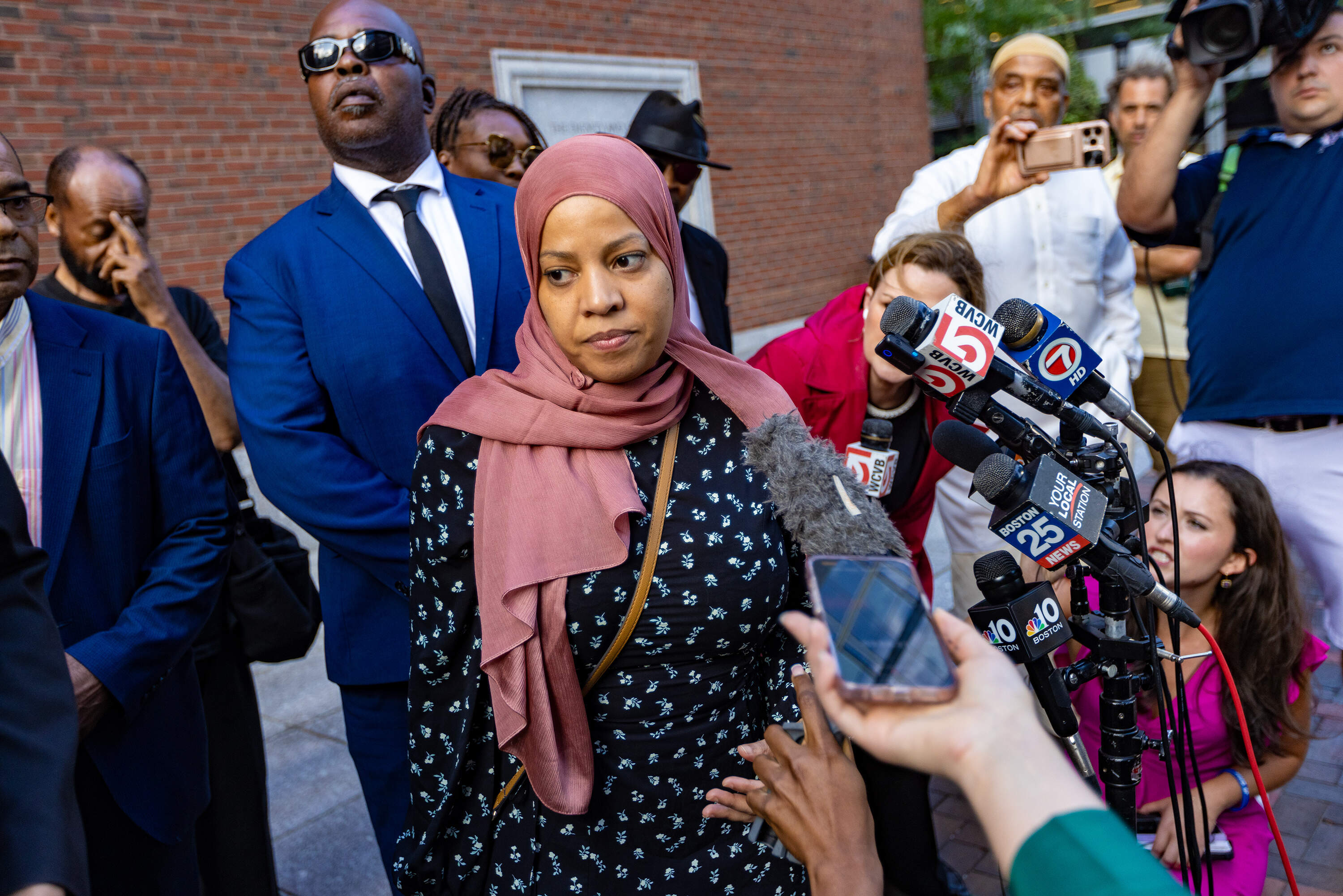Former Boston City Councilor Tania Fernandes Anderson walks away after speaking to the media after being sentenced to one month in prison, followed by three years of supervised release, and was ordered to pay $13,000 in restitution. (Jesse Costa/WBUR)