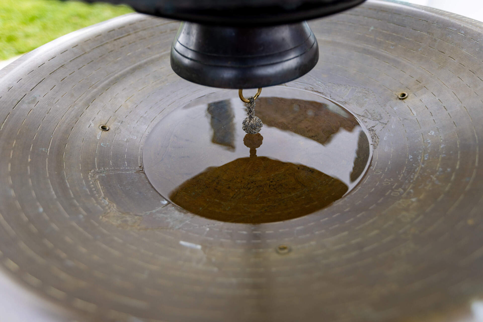 The bowl of the water clock is filled with water, covering the engraving of the 2070 projection renderings from the 2016 Climate Ready Boston reports, which reveal vulnerable coastal areas and predict flood levels for the next 45 years. (Jesse Costa/WBUR)