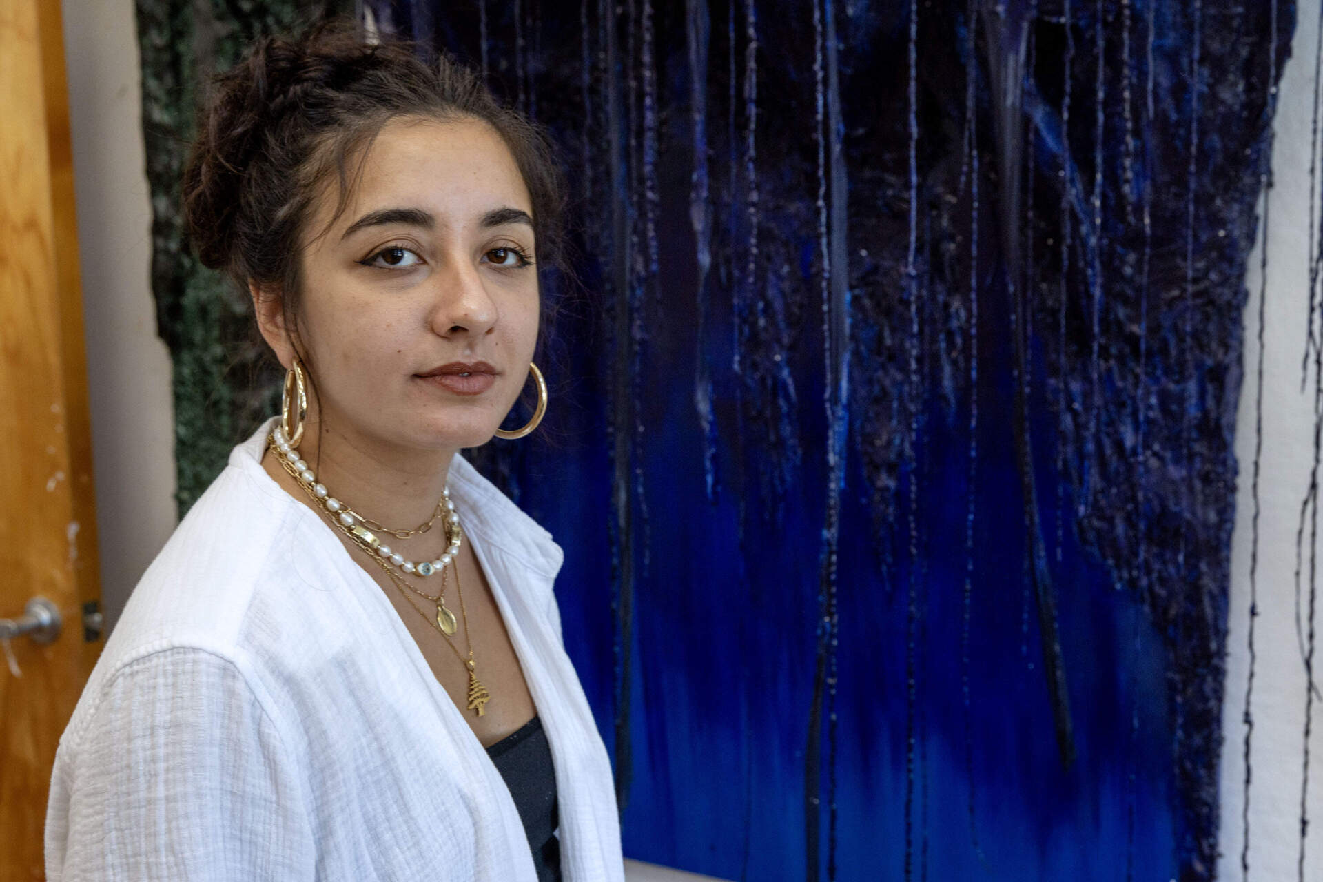 Artist Jo Nanajian in front of her piece "Watery Willow" at her studio in Somerville. (Robin Lubbock/WBUR)