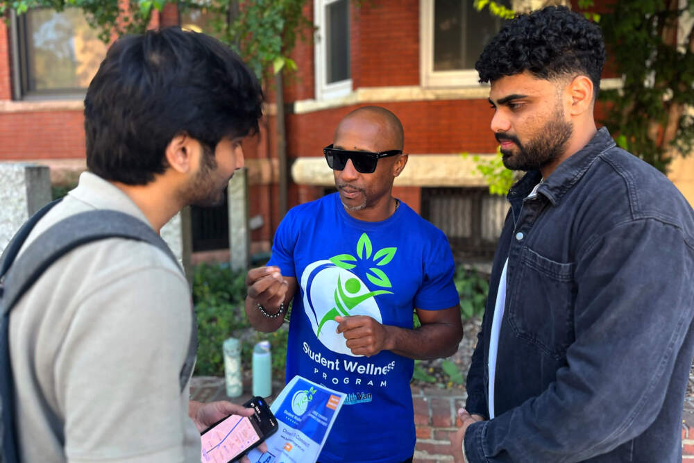 Dion RamBo Tells Sai Praharshhh, A Northeastern Graduet Student, and HIS FREDUOUNOUTS Counselling Services. (Emily Piper-Vallilla / WBUR)