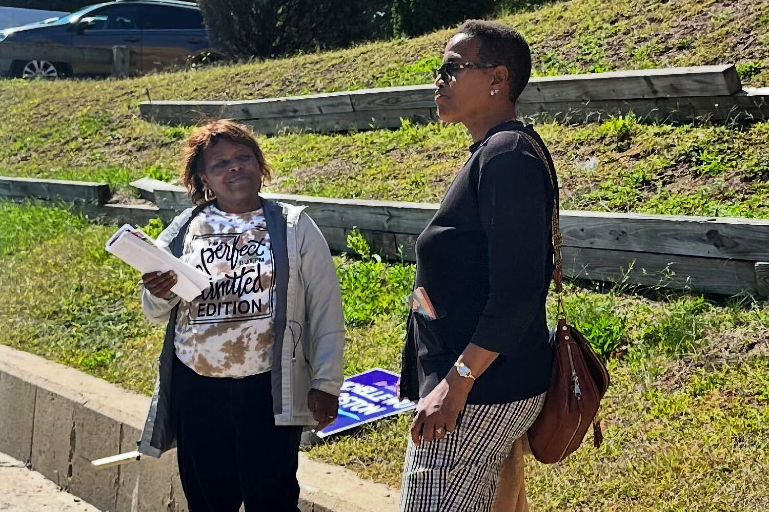 Grace Richardson, left, stands outside a polling location in Mattapan during Boston's preliminary elections in September. She supports a National Guard presence in the city. (Simón Rios/WBUR)