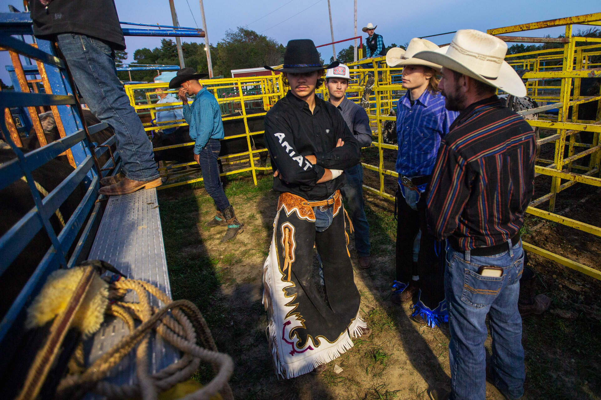 Bull riders examine the bulls and chat before the competition. (Jesse Costa/WBUR)