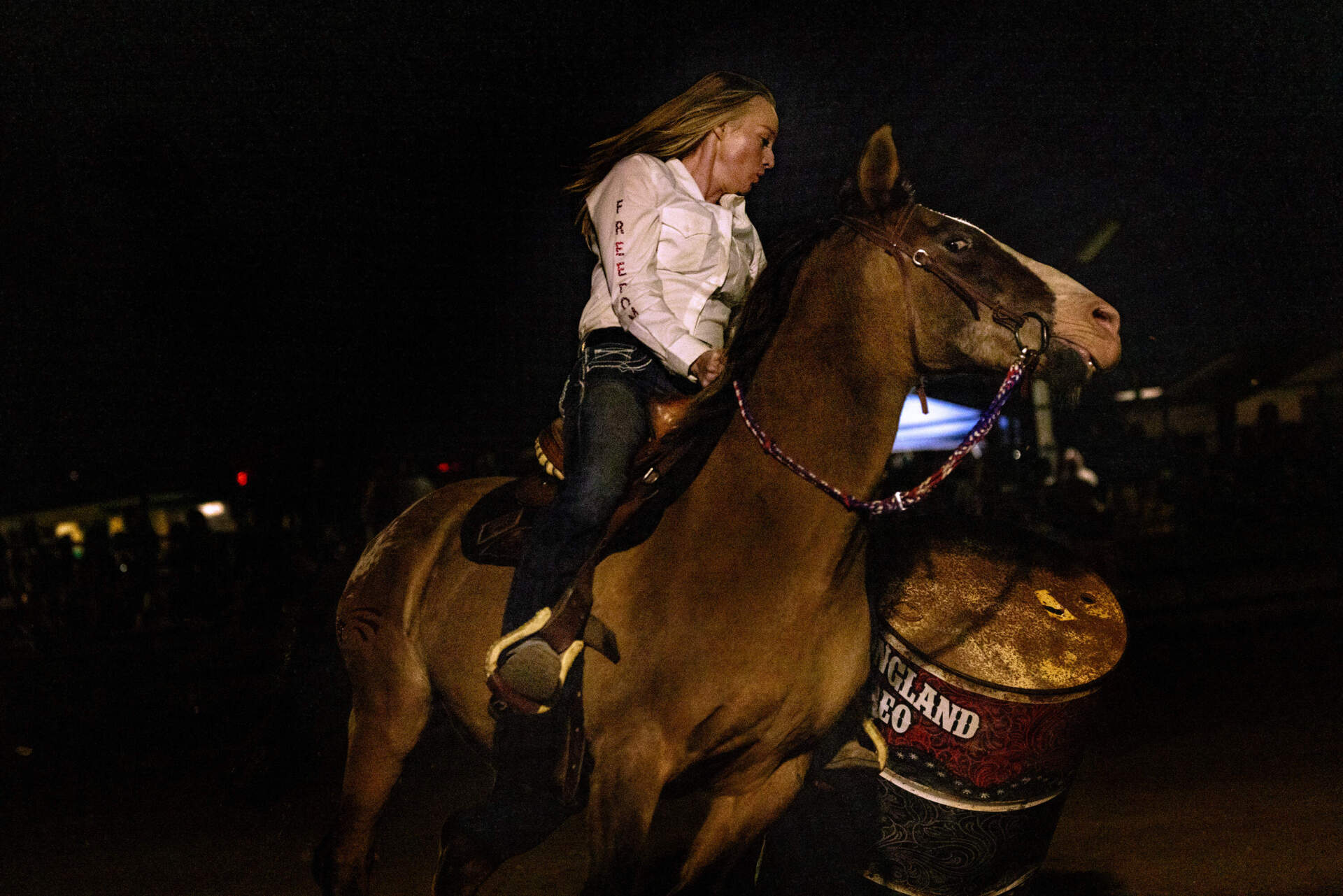 Melissa Martin knocks down a barrel as she takes a turn during the professional barrel racing competition. (Jesse Costa/WBUR)