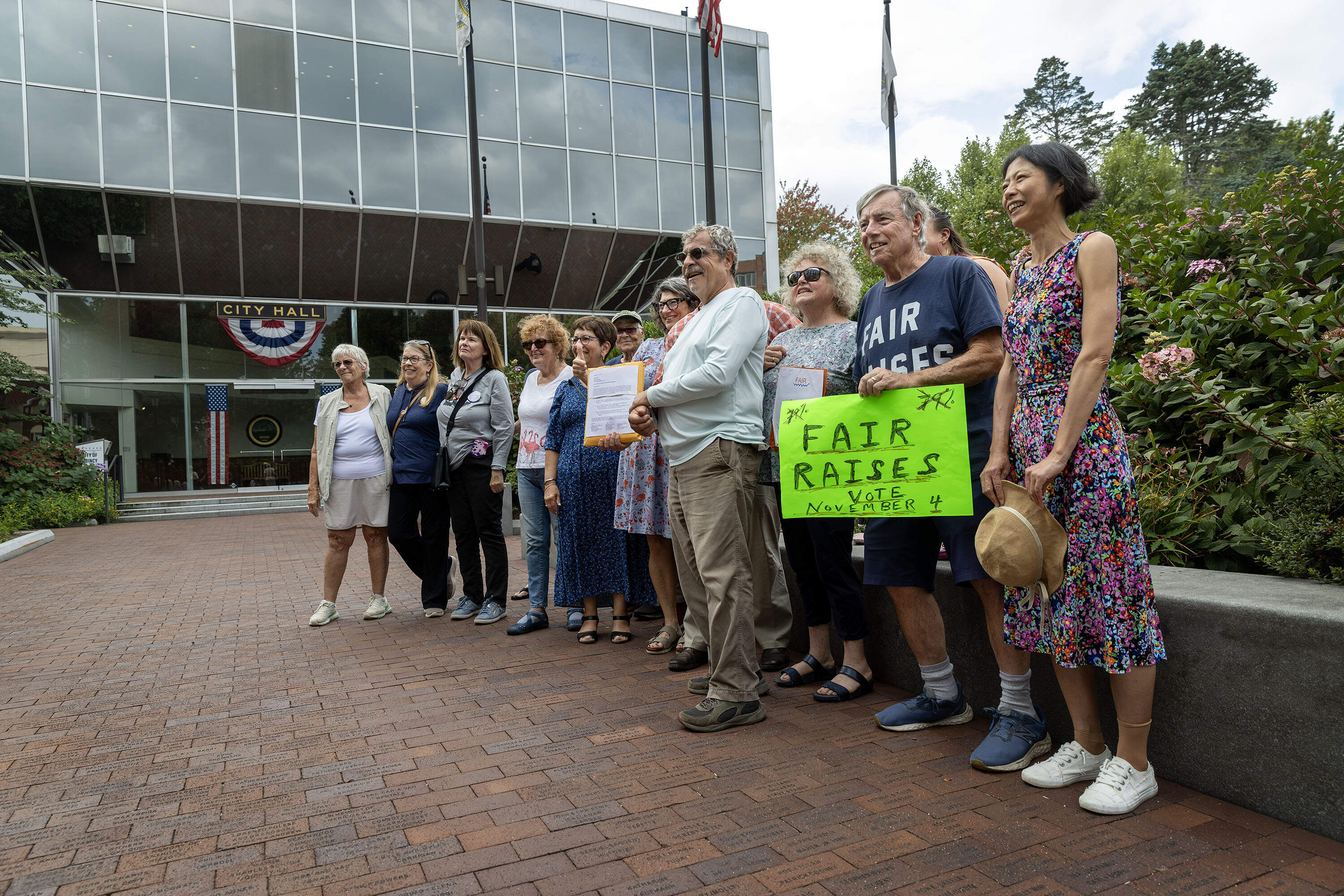 A group of supporters of Quincy Citizens for Fair Raises gather outside Quincy City Hall before handing in signatures at the city's elections office. (Robin Lubbock/WBUR)