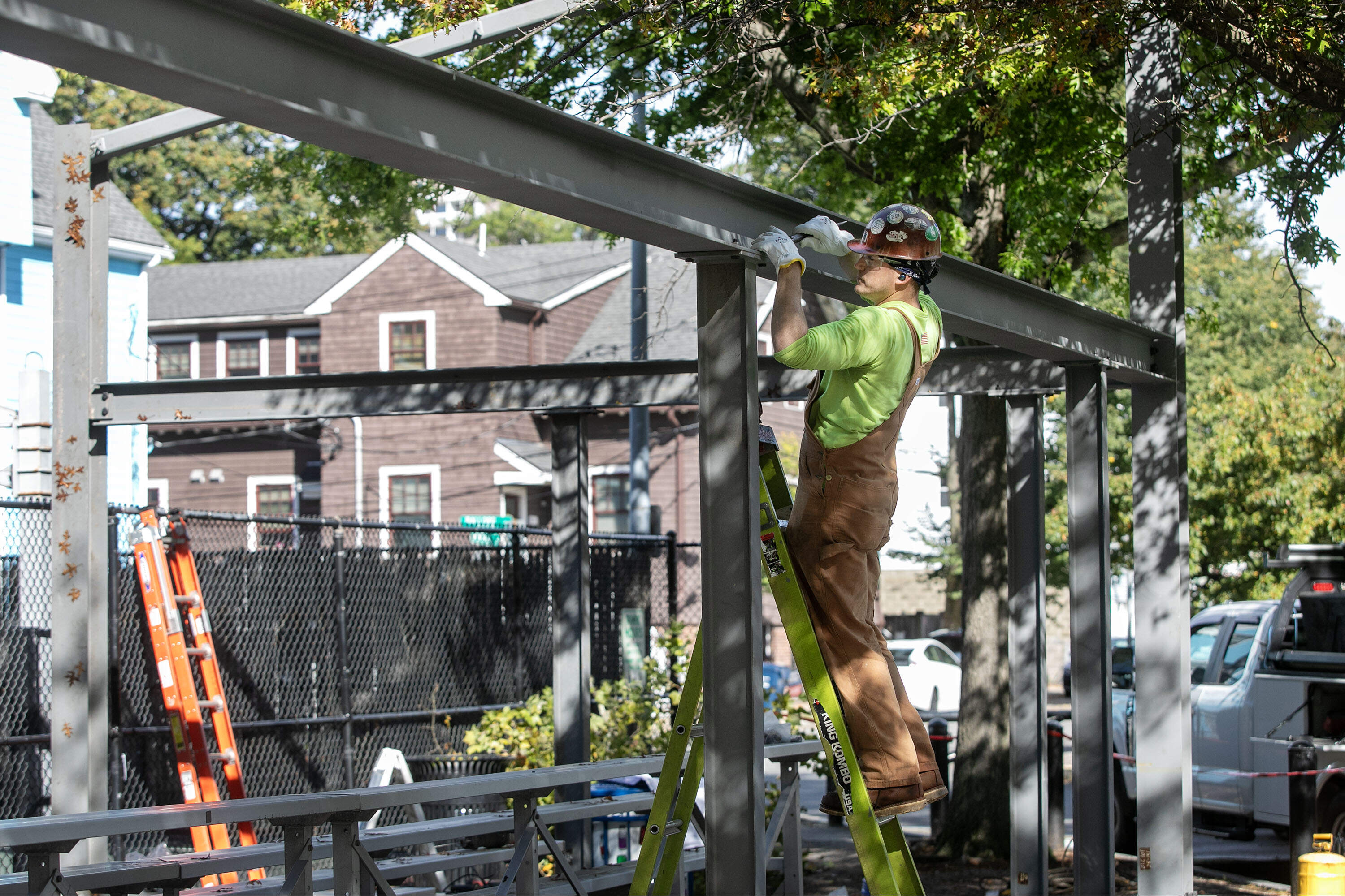With the steel in place, an ironworker tightens bolts on Brazier's shade structure. (Robin Lubbock/WBUR)