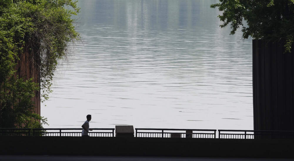 The Ohio River provides the backdrop as a jogger makes a midday run along the riverfront in Louisville, Kentucky. (Ed Reinke/AP)