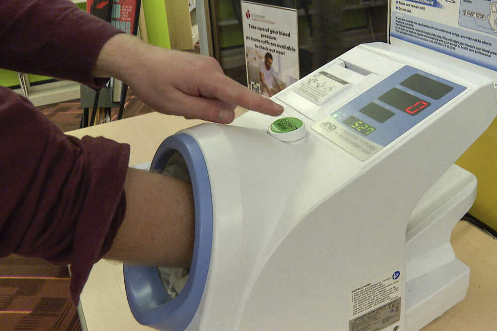 A patron uses a free blood pressure machine at the public library in Kansas City, Mo., on Nov. 19, 2024. (Nick Ingram/AP)