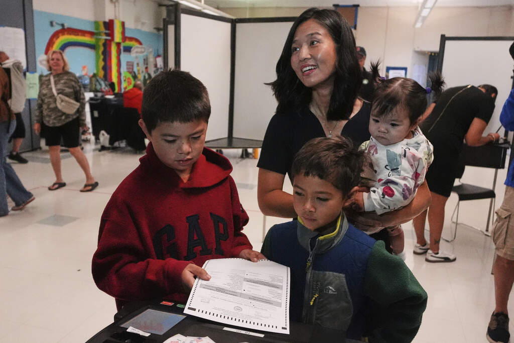 Boston Mayor Michelle Wu votes with her children Blaise, Cass and Mira at a polling place in Roslindale Tuesday morning. (Charles Krupa/AP)