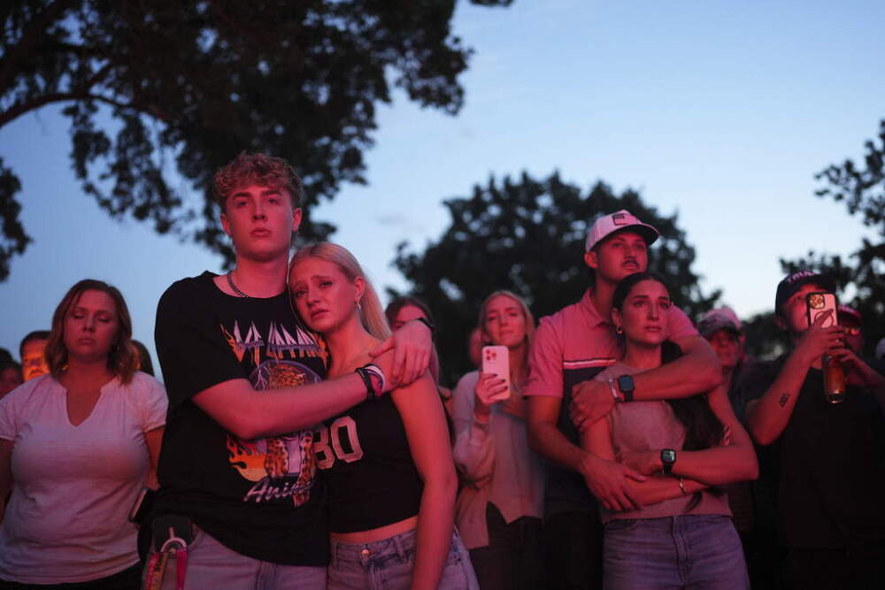 Utah Valley University students embrace during a vigil for Charlie Kirk, who was shot and killed on September 11 in Orem, Utah. (Lindsey Wasson/AP)