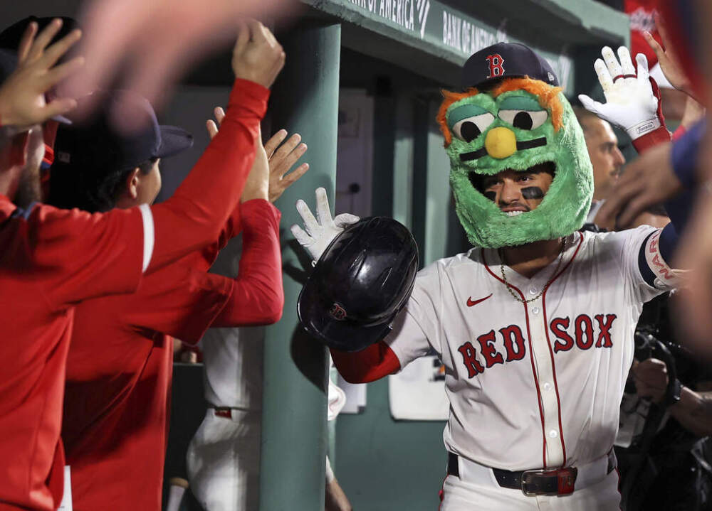 Boston Red Sox's Carlos Narvaez, front right, celebrates with teammates following his solo home run in the bottom of the first inning of a baseball game against the New York Yankees, Sunday, Sept. 14, 2025, in Boston. (AP Photo/Jim Davis)