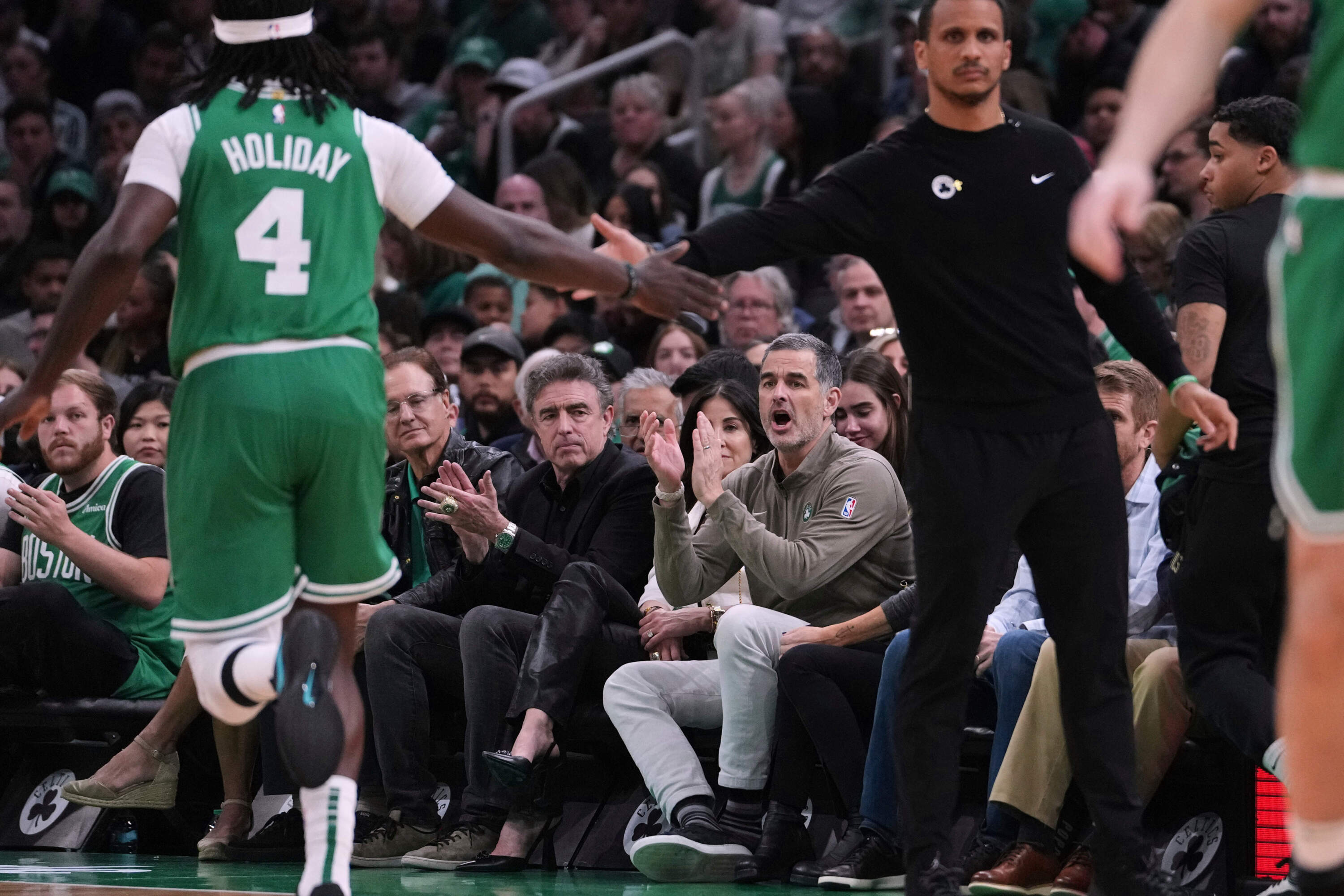 Boston Celtics owner Bill Chisholm, seated right, applauds during game 2 of the playoff series against the Orlando Magic in April. (Charles Krupa/AP)
