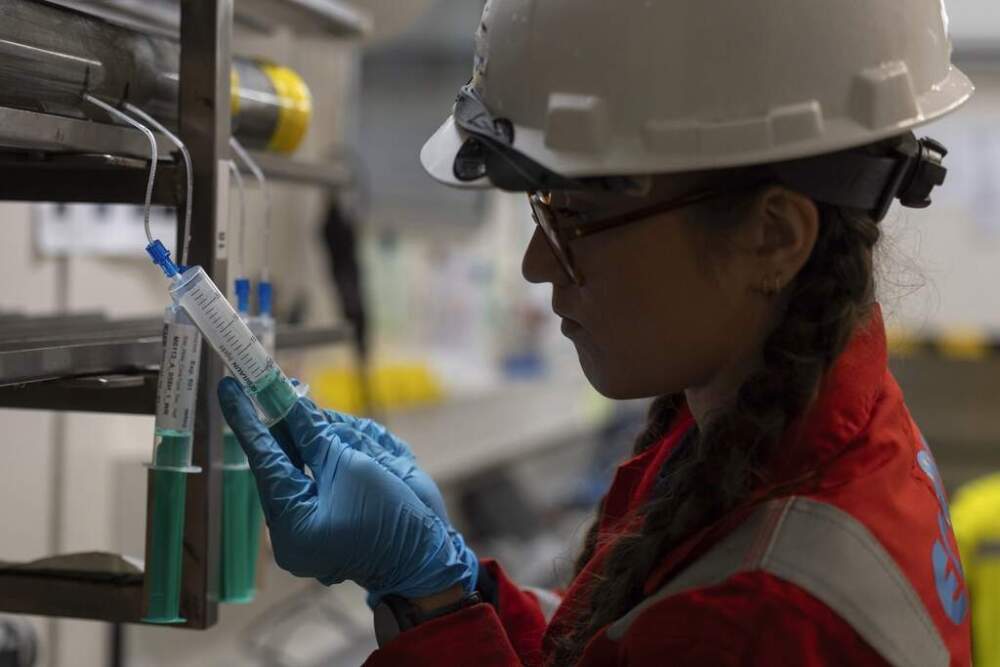 Expedition 501 researcher Alizé Longeau collects water samples from cores aboard the Liftboat Robert platform, in the North Atlantic, in the early morning hours, Sunday, July 20, 2025. (Carolyn Kaster/AP)