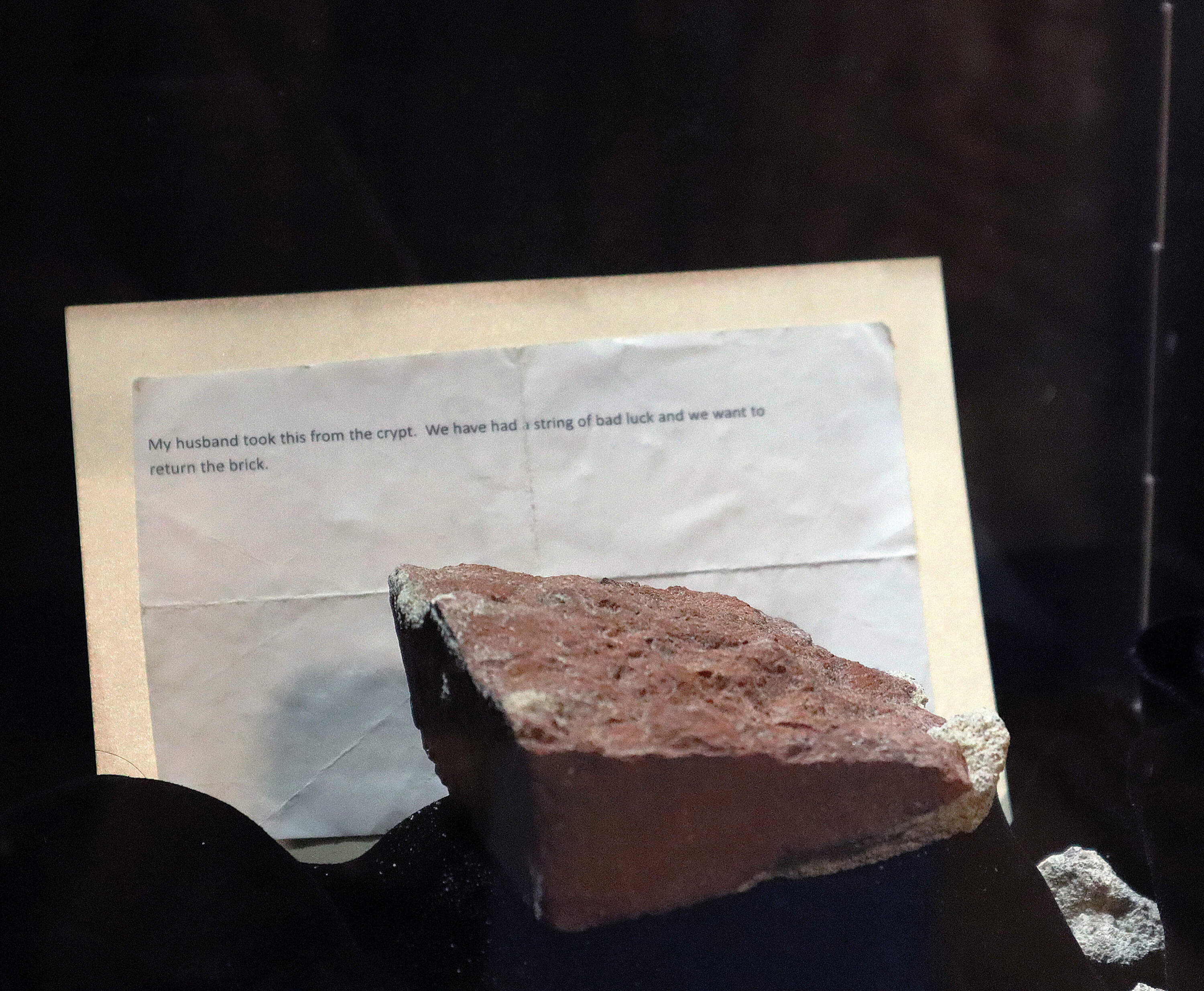 Closeup of the letter and returned "cursed" brick and the letter sent to Old North Church. (Lily Hansen for WBUR)