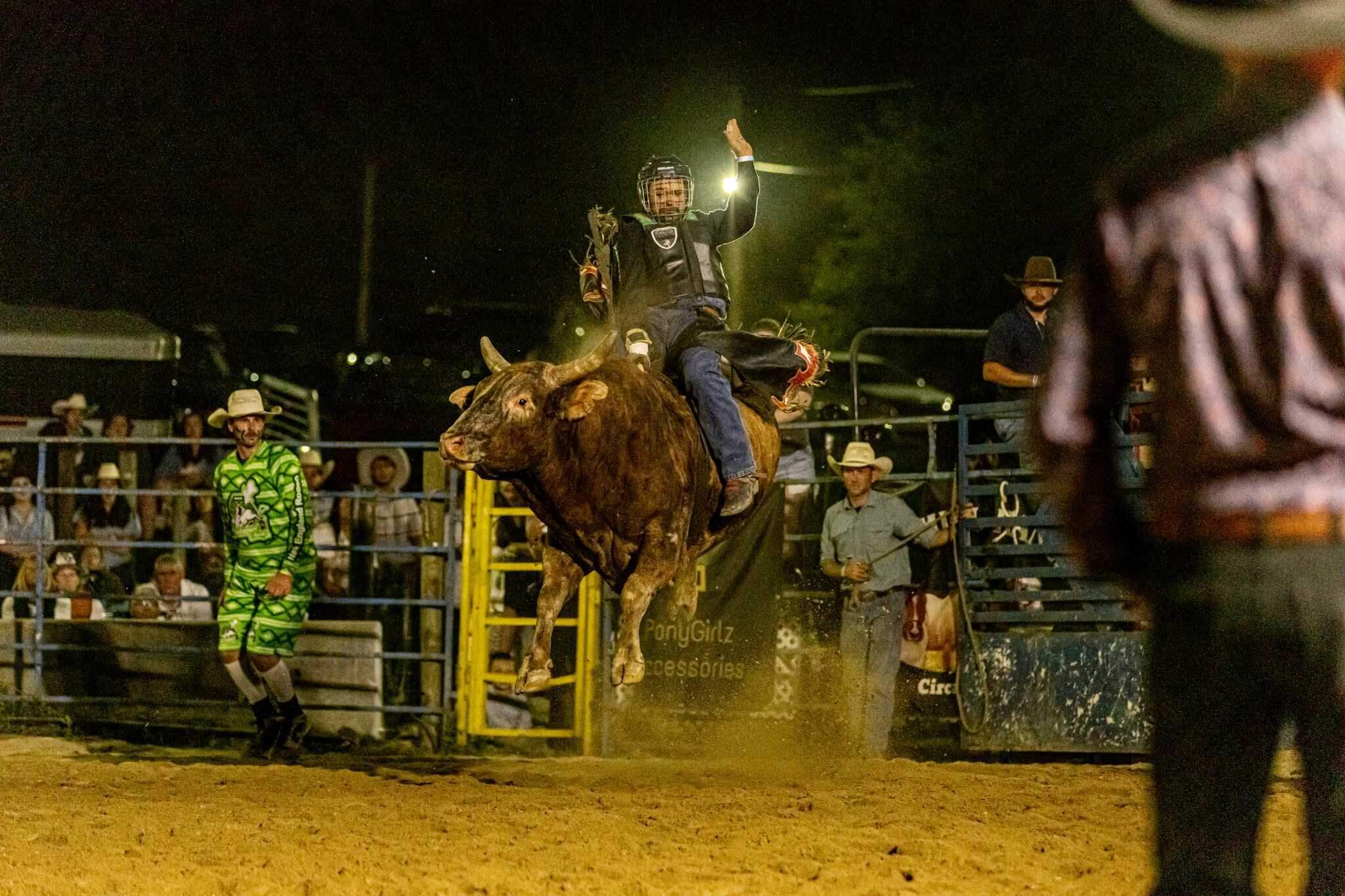 A bull rider maintains proper form on a bucking bull. (Jenn Carmichael/Flex It Photography)