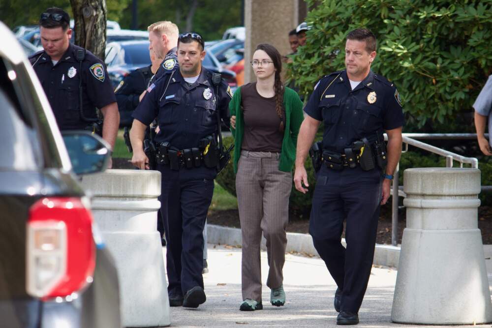 Eleanor Reid, 33, is arrested outside of the Burlington ICE field office on Friday Sept. 12, 2025. (Miriam Wasser/WBUR)