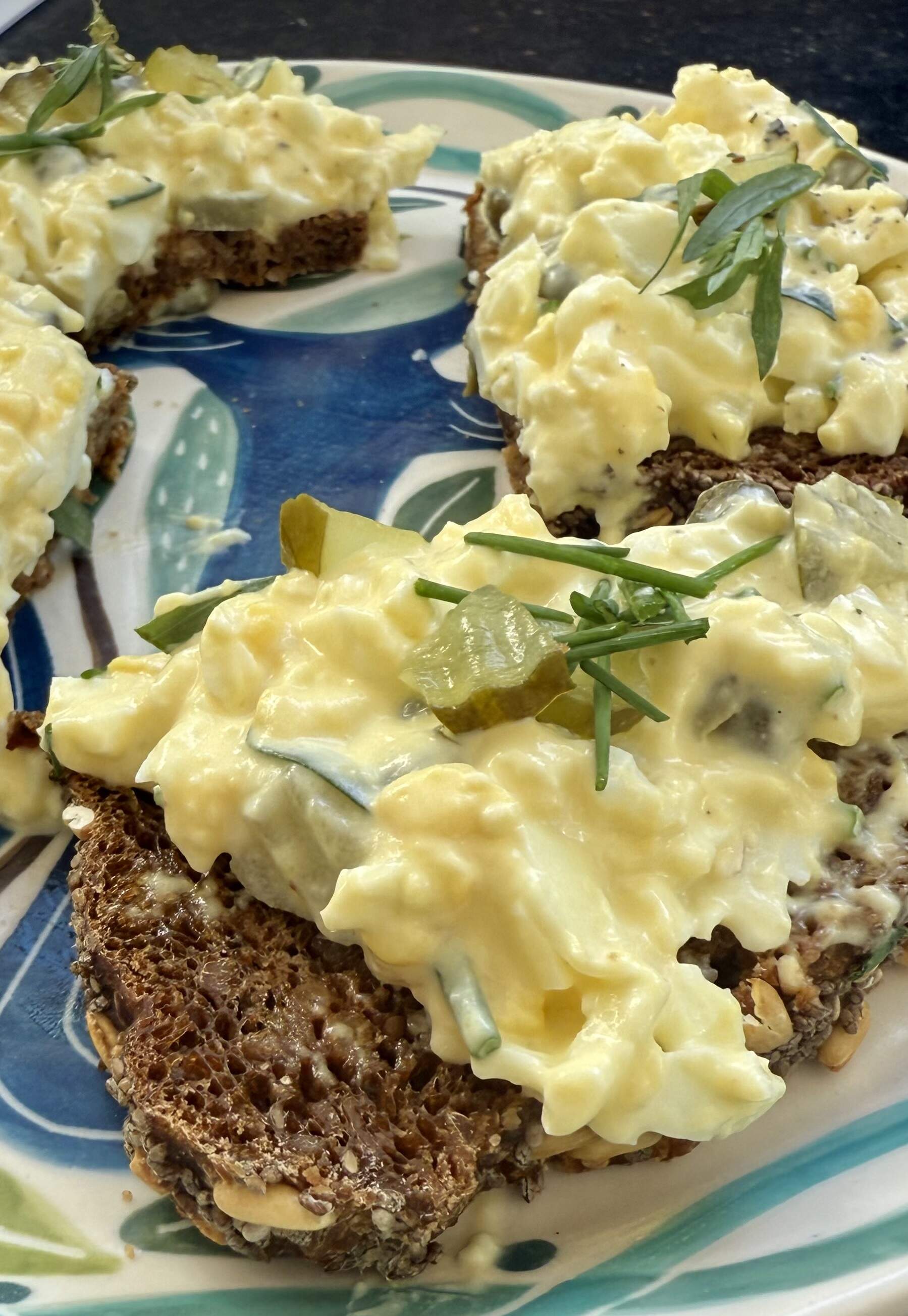 Egg salad with pickles, capers and dill over whole-grain bread. (Kathy Gunst/Here &amp; Now)