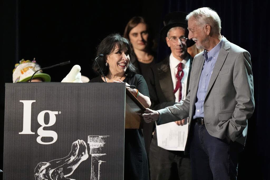 The Ig Nobel Prize for pediatrics is accepted by Julie Mennella and Gary Beauchamp, for studying what a nursing baby experiences when the baby's mother eats garlic. (Robert F. Bukaty/AP)