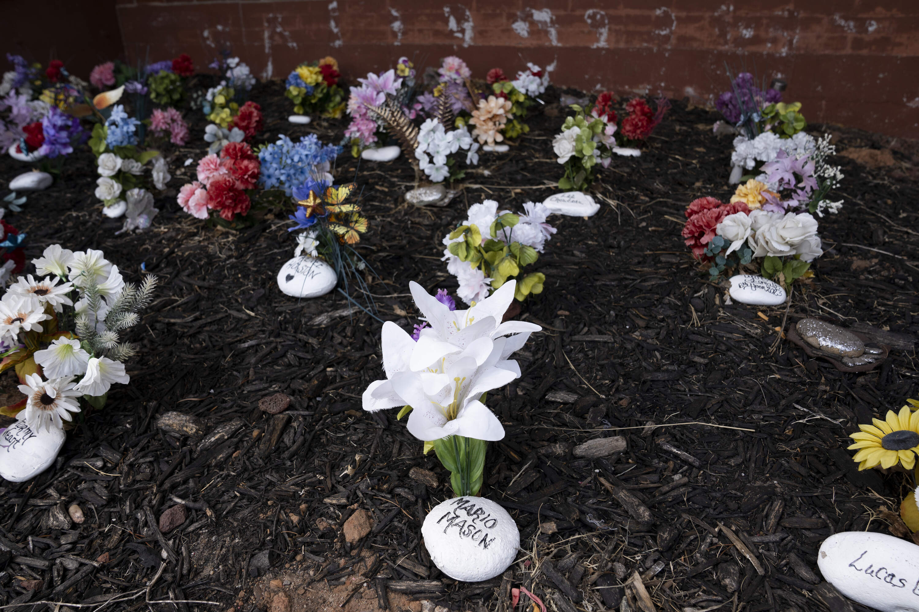 Rocks and artificial flowers fill a memorial garden in front of the Oklahoma County Jail in Oklahoma City, Oklahoma on Thursday August 21, 2025. (Nick Oxford for Here & Now)