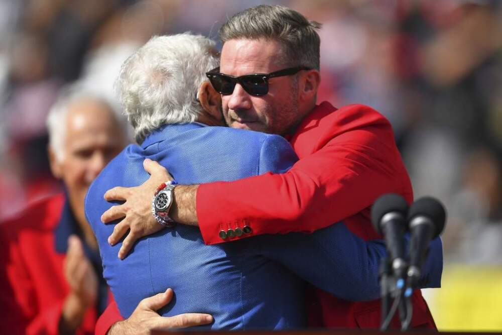 New England Patriots owner Robert Kraft, left, and former Patriots wide receiver Julian Edelman, right, embrace during Patriots Hall of Fame ceremonies for Edelman during halftime at an NFL football game against the Pittsburgh Steelers, Sunday, Sept. 21, 2025, in Foxborough, Mass. (Steven Senne/AP)