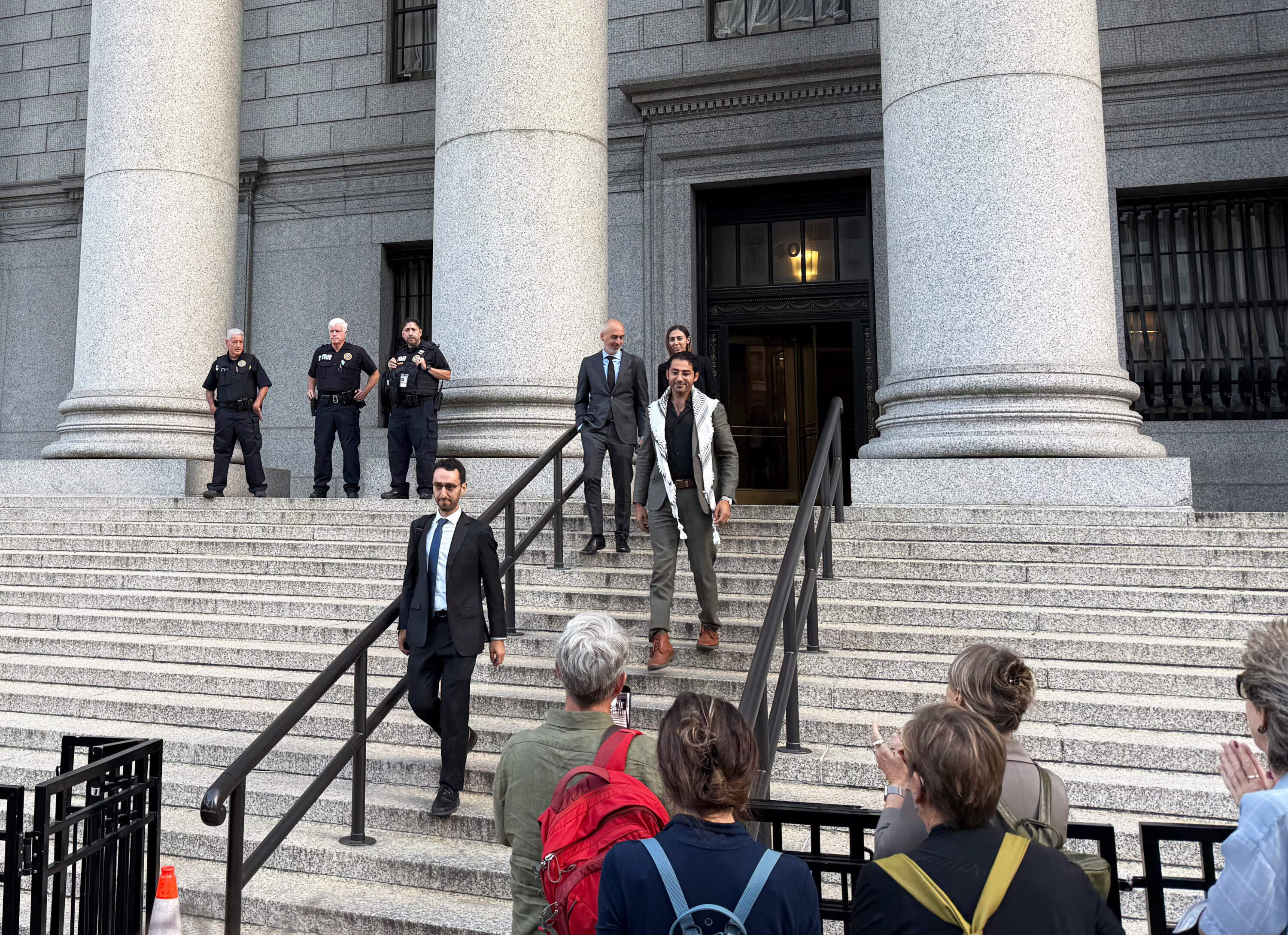Columbia University graduate Mohsen Mahdawi walks down the steps of the federal court in New York following a hearing. The Trump administration has appealed a lower court's ruling that forced it to release Mahdawi and Tufts University doctoral student Rümeysa Öztürk from detention, after the two were arrested by immigration enforcement agents. (Walter Wuthmann for WBUR)