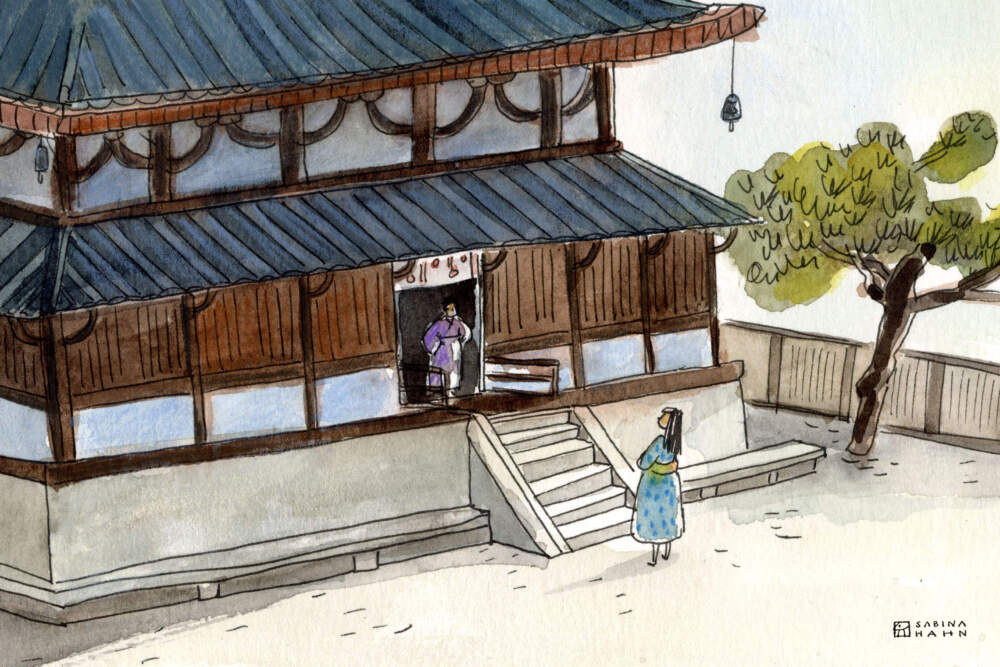 Two people outside a pagoda. (Sabina Hahn for WBUR)