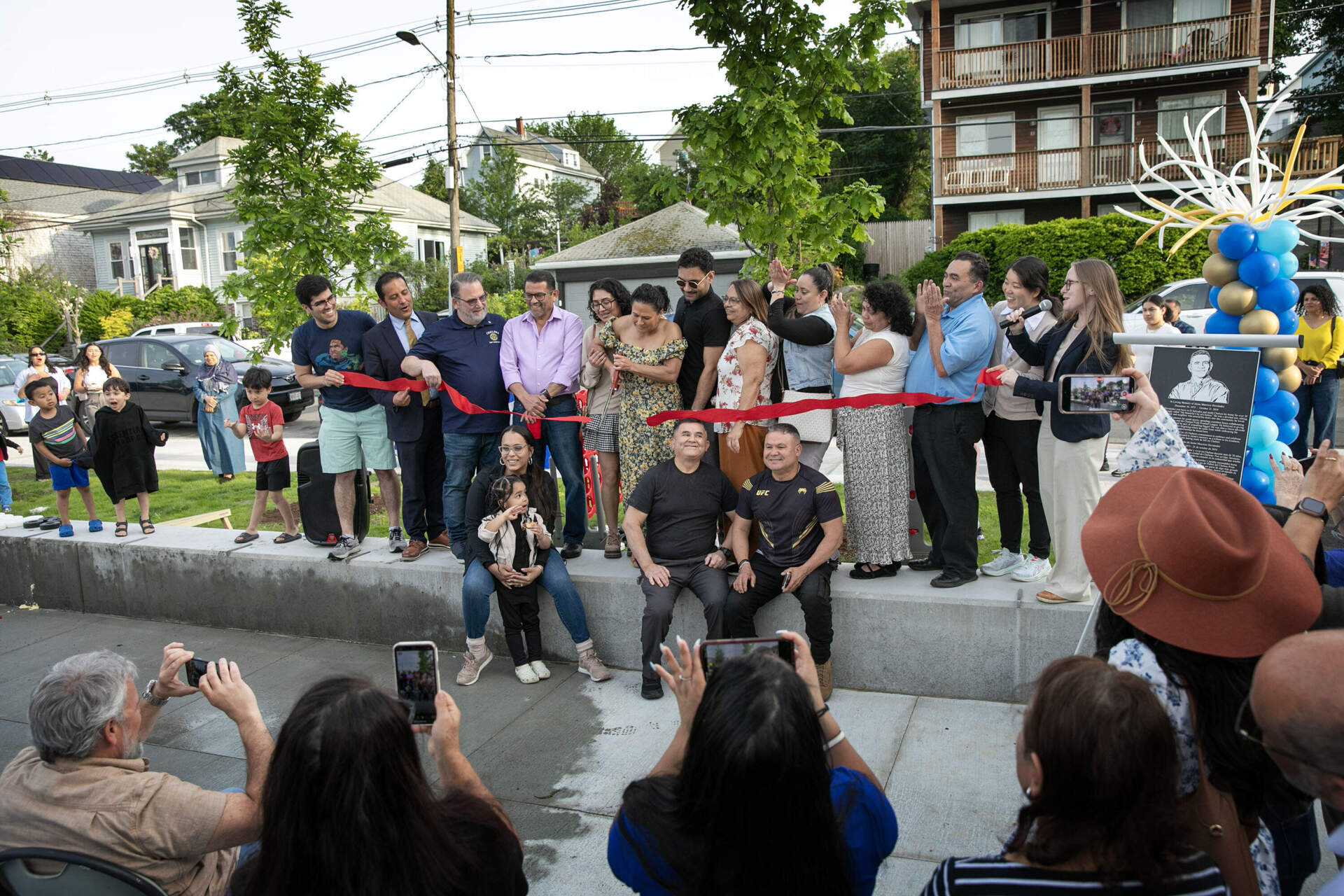City officials and community leaders hold a ribbon cutting at Jaime Hernandez water park in Chelsea in May 2025. (Robin Lubbock/WBUR)