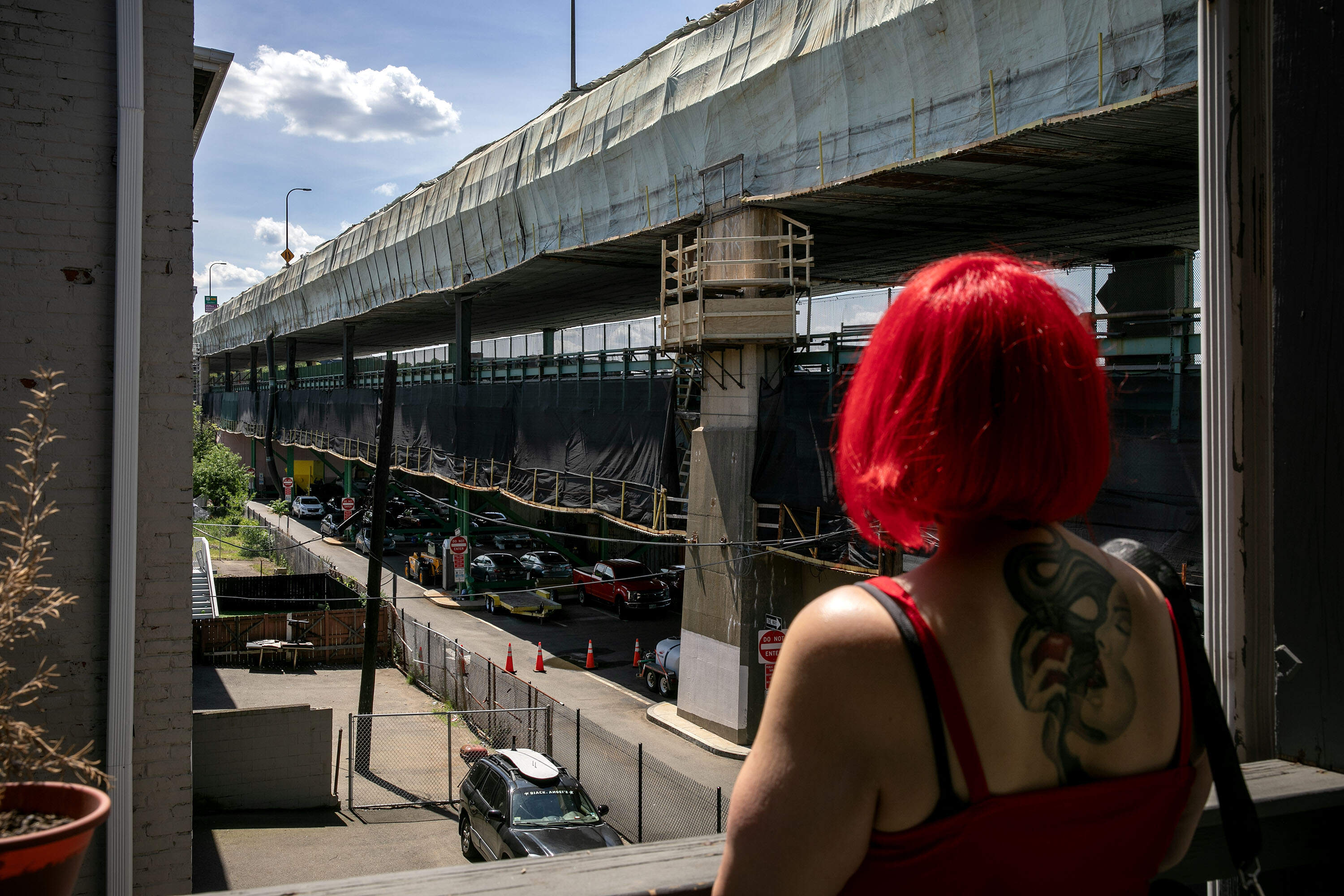 Liza Henriquez on one of the back decks of the building where she lives in Chelsea, just a short distance from the Tobin Bridge (Robin Lubbock/WBUR)