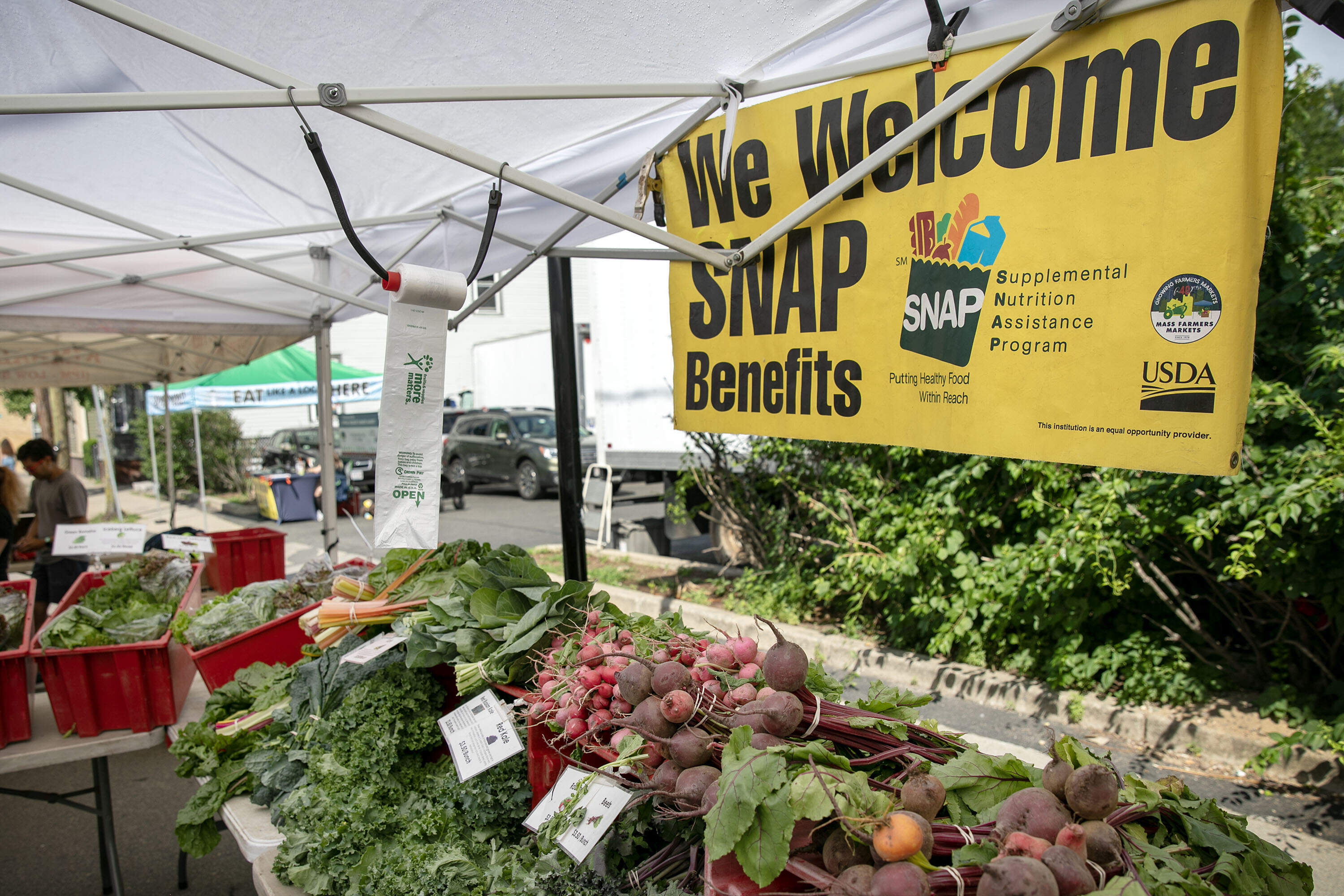 A sign at the Central Square farmers market in Cambridge welcomes payment through the Supplemental Nutrition Assistance Program.