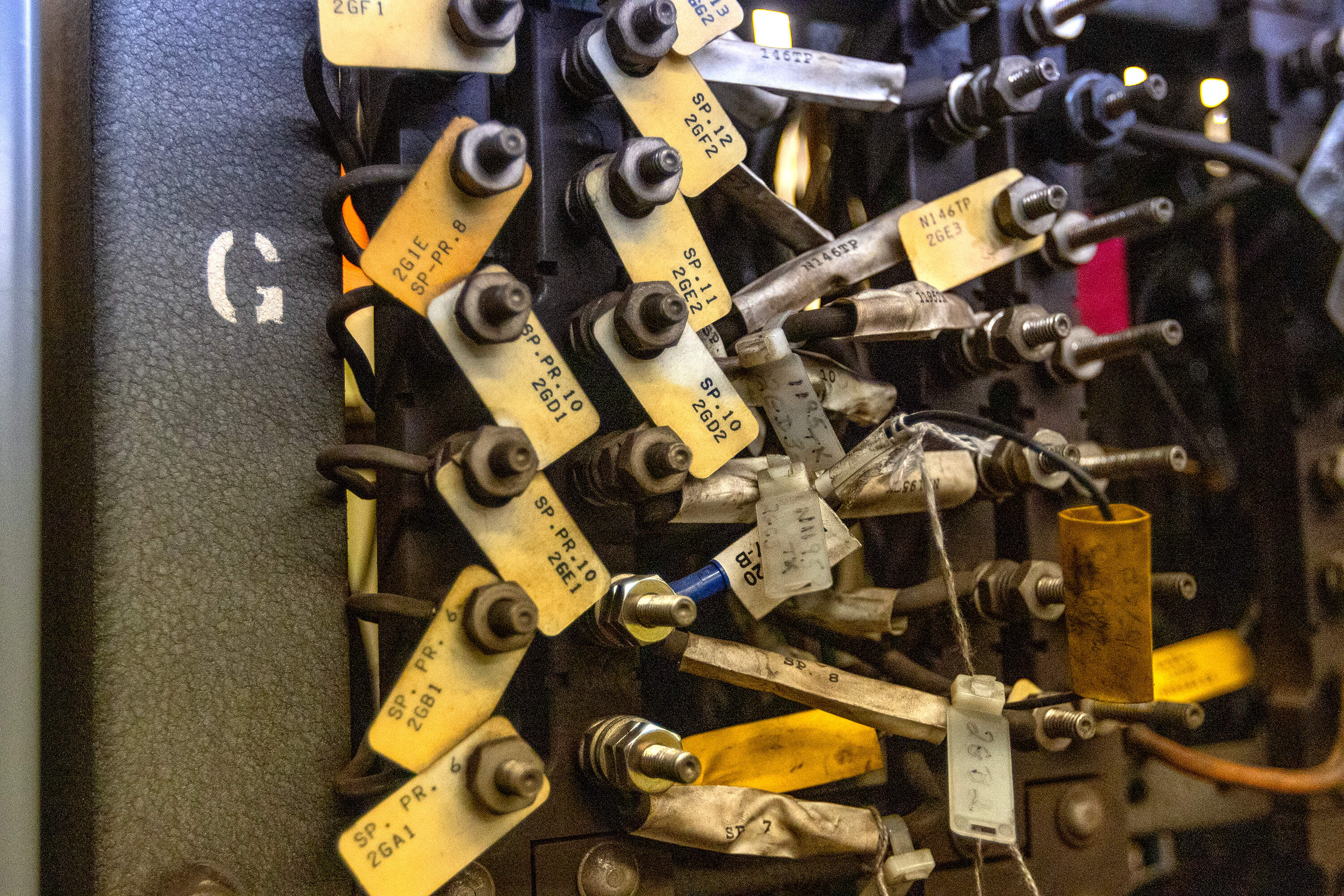 Close up of the old wiring board with tags identifying each signal in the tunnel. These connected the signal to a corresponding switch in the room. (Jesse Costa/WBUR)