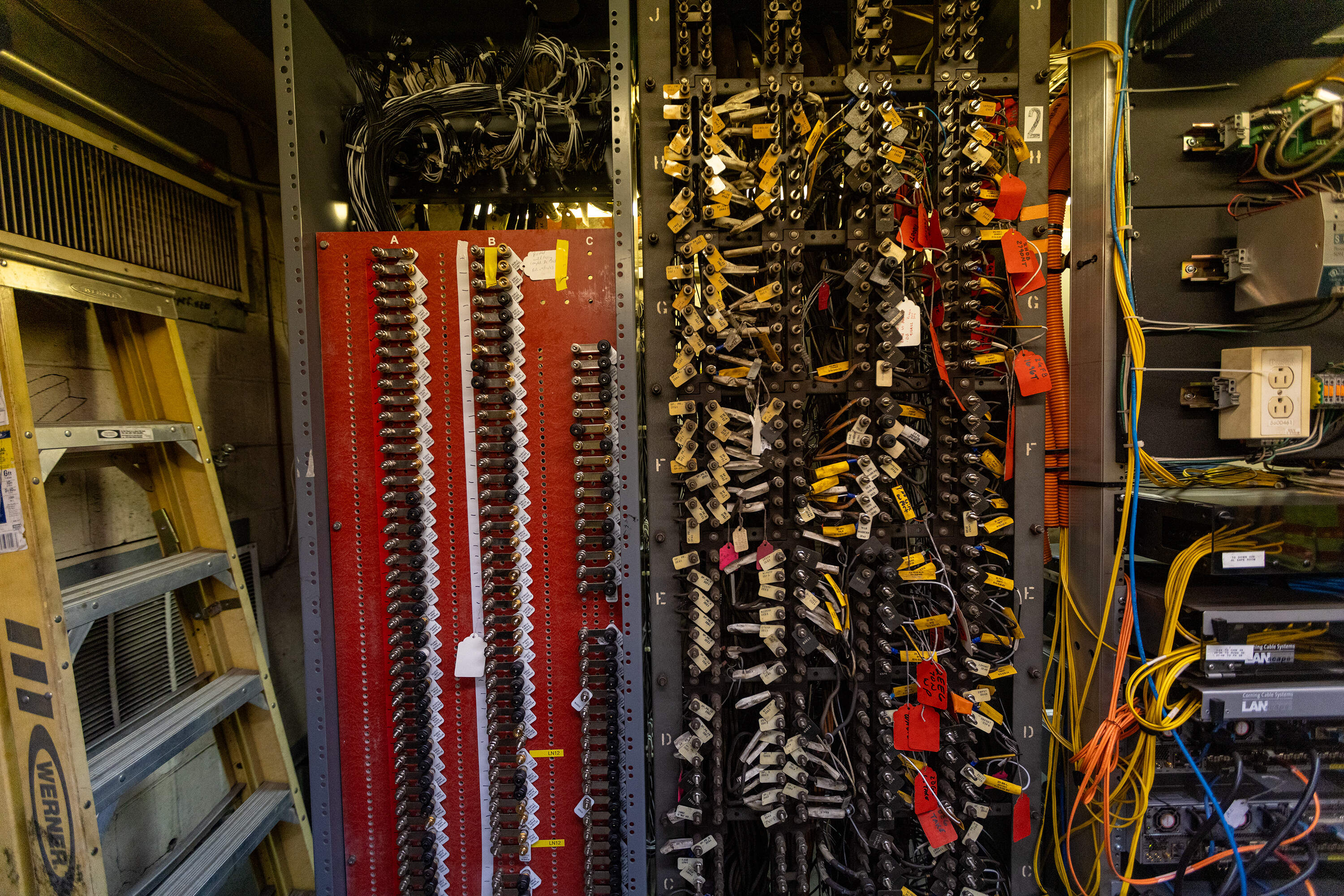 In a signal room, updated equipment on the left contrasts with old equipment on the right. (Jesse Costa/WBUR)