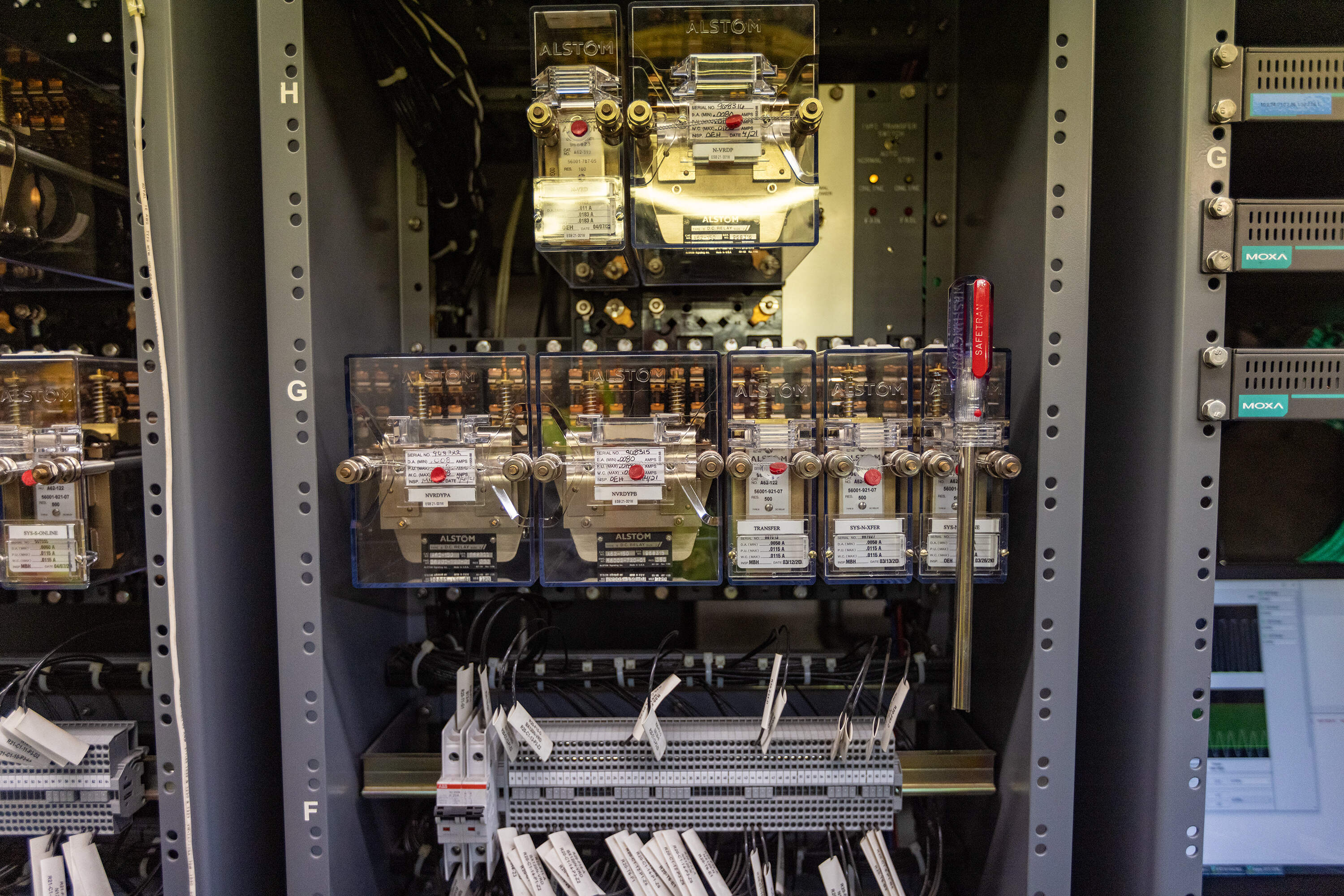 A signal worker monitors the modernized equipment in a signal room. (Jesse Costa/WBUR)