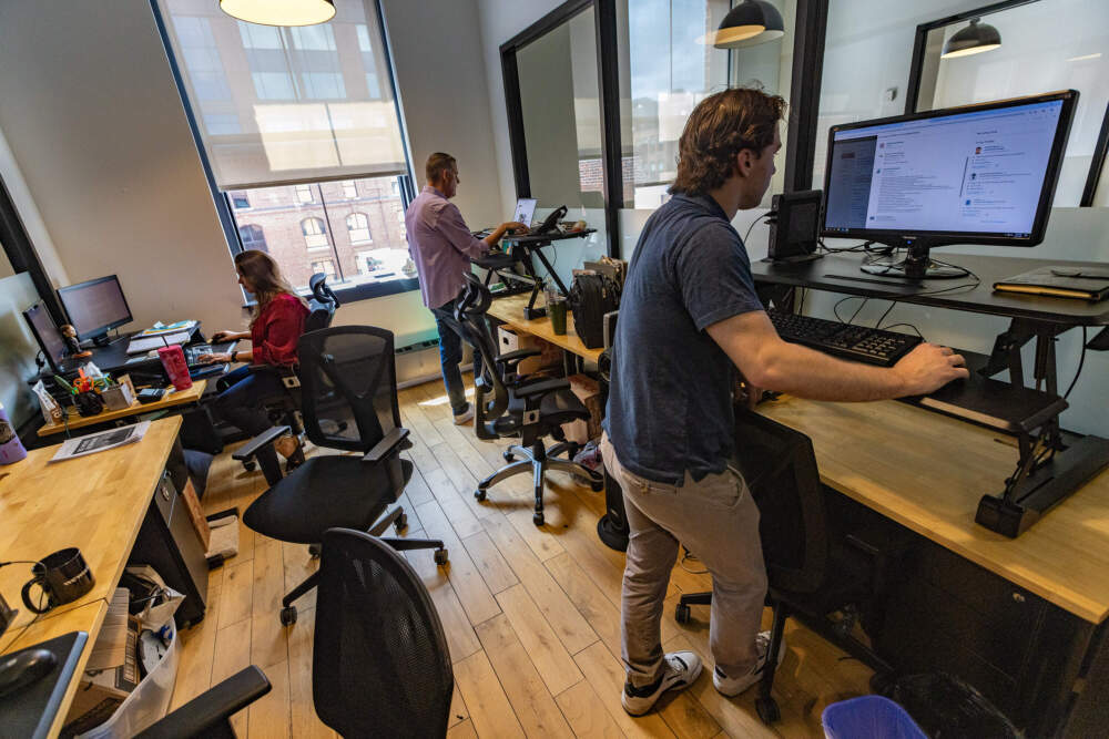 David Leshowitz, back right, and his staff in the office of Management Recruiters - The Boston Group near North Station. (Jesse Costa/WBUR)