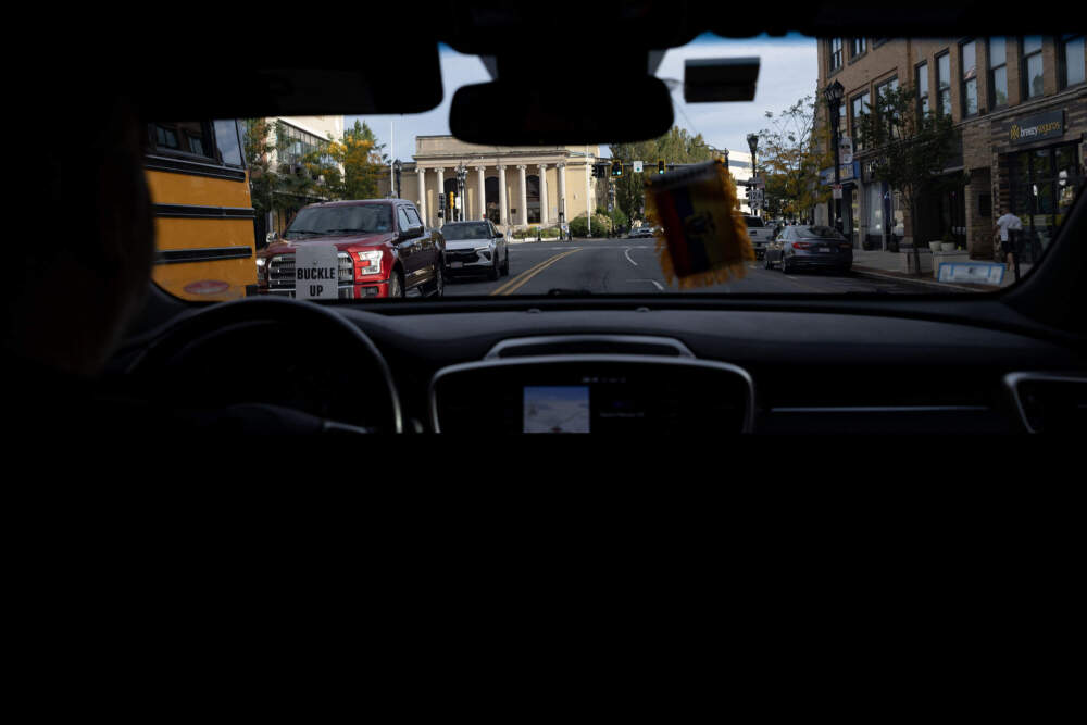 A volunteer with the group LUCE drives along Concord Street in Framingham. (Robin Lubbock/WBUR)